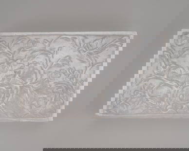 A LAVENDER JADEITE BOX AND COVER, c. 1920s: A LAVENDER JADEITE BOX AND COVER, c. 1920s China, Republic period (1912-1949). Finely carved lidded box of rectangular shape with four accentuated feet. The lid shows dense decoration, finely chiseled