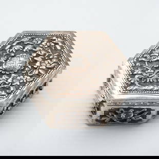 A SILVER MINIATURE BOX WITH BIRDS AND FLOWERS: A SILVER MINIATURE BOX WITH BIRDS AND FLOWERS South China / Vietnam, 1880s &#8211; 1920s. Of hexagonal form with a hinged lid, finely chased, each side adorned with a panel depicting floral designs an