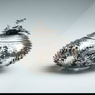 A SILVER GOURD-SHAPED MINIATURE BOX: A SILVER GOURD-SHAPED MINIATURE BOX South China / Vietnam, 1880s &#8211; 1920s. The compressed gourd-shaped body raised on a short circular foot, finely embossed, and incised various mythical creature