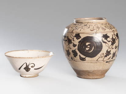 A CERAMIC CIZHOU JAR AND BOWL, SONG DYNASTY: A CERAMIC CIZHOU JAR AND BOWL, SONG DYNASTY China, 960-1279. The bowl rising from a short straight foot to a gently everted rim, painted in brownish-black on a white slip with a stylized flower head a