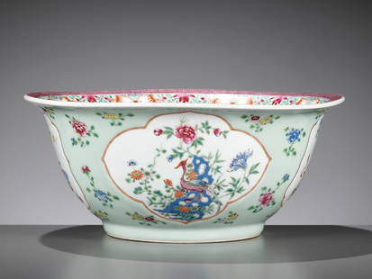 A CELADON-GLAZED FAMILLE ROSE 'HUNDRED ANTIQUES' PORCELAIN BOWL, QING DYNASTY: A CELADON-GLAZED FAMILLE ROSE 'HUNDRED ANTIQUES' PORCELAIN BOWL, QING DYNASTY China, 18th &#8211; early 19th century. The large bowl stands on a short, slightly tapered foot and rises to an everted ri