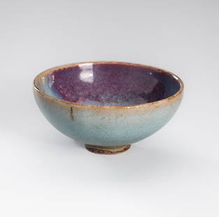 A SMALL 'JUNYAO' GLAZED PORCELAIN BOWL, QING DYNASTY OR EARLIER: A SMALL 'JUNYAO' GLAZED PORCELAIN BOWL, QING DYNASTY OR EARLIER China, 1644-1912 or earlier. The bowl with rounded sides rising from a circular foot, covered in a thick, finely crackled, milky-blue gl