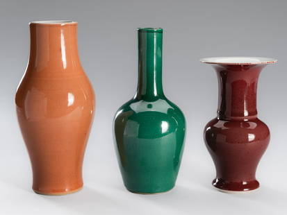 A GROUP OF THREE MONOCHROME GLAZED PORCELAIN VASES, LATE QING DYNASTY TO REPUBLIC PERIOD: A GROUP OF THREE MONOCHROME GLAZED PORCELAIN VASES, LATE QING DYNASTY TO REPUBLIC PERIOD China, late 19th to early 20th century. Comprising a baluster vase covered in a pale orange glaze with a netwo