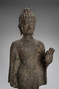 A BRONZE PRE ANGKOR-STYLE FIGURE OF BUDDHA SHAKYAMUNI: A BRONZE PRE ANGKOR-STYLE FIGURE OF BUDDHA SHAKYAMUNI Cambodia, 19th century or earlier. Sensuously carved with his left hand raised in vitarka mudra and the right arm stretched alongside the body, dr