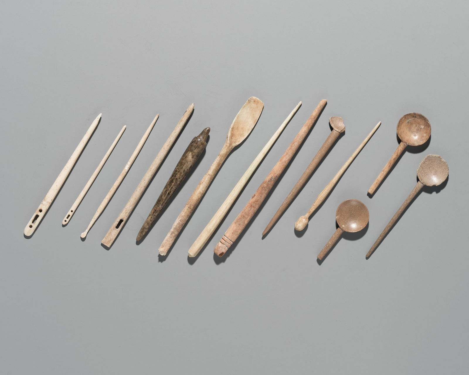 A GROUP OF THIRTEEN BONE SPOONS, NEEDLES, AND PINS, 1ST MILLENNIUM AD OR EARLIER: A GROUP OF THIRTEEN BONE SPOONS, NEEDLES, AND PINS, 1ST MILLENNIUM AD OR EARLIER This lot is a museum deaccession and is therefore offered without reserve Europe or West Asia. Comprising five spoons,