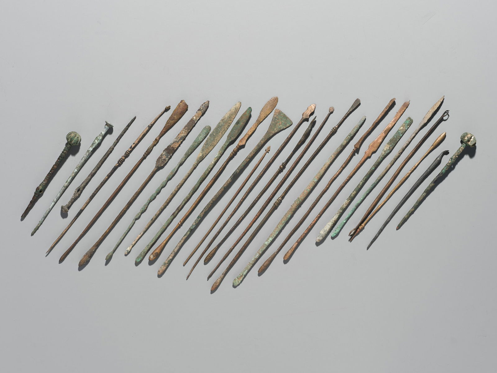A GROUP OF TWENTY-FIVE GREEK AND ROMAN BRONZE PINS, SPOONS AND TOOLS, 1ST MILLENNIUM AD AND EARLIER (1 of 9)