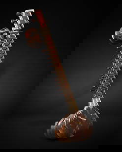 A BONE-INLAID CARVED WOOD SITAR BY RADHA KRISHNA SHARMA & CO., 20TH CENTURY: A BONE-INLAID CARVED WOOD SITAR BY RADHA KRISHNA SHARMA & CO., 20TH CENTURY  This lot is a museum deaccession and is therefore offered without reserve India, Calcutta. The gourd-shaped body (tumba) ri