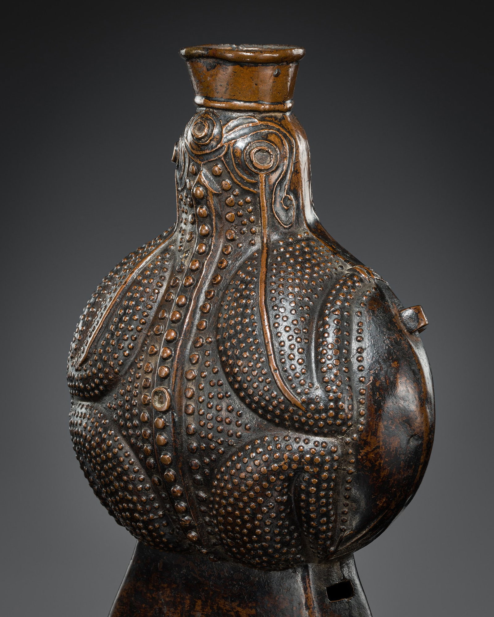 A 'FROG' COPPER ALLOY FLASK, TIBET, 18TH-19TH CENTURY: A 'FROG' COPPER ALLOY FLASK, TIBET, 18TH-19TH CENTURY Imaginatively cast as a large toad holding the flask nozzle in its mouth and with two loop handles on the sides for suspension by a strap that wou