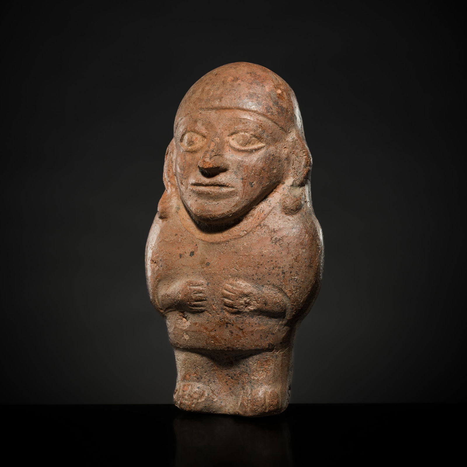 A POTTERY FIGURE OF A WOMAN, VICÚS OR MOCHE CULTURE: A POTTERY FIGURE OF A WOMAN, VICÚS OR MOCHE CULTURE Northern Peru, Vicús or Moche civilization (c. 200 BC - 500 AD). Boldly modeled, the figure wears traditional headgear, her hands resting upon her