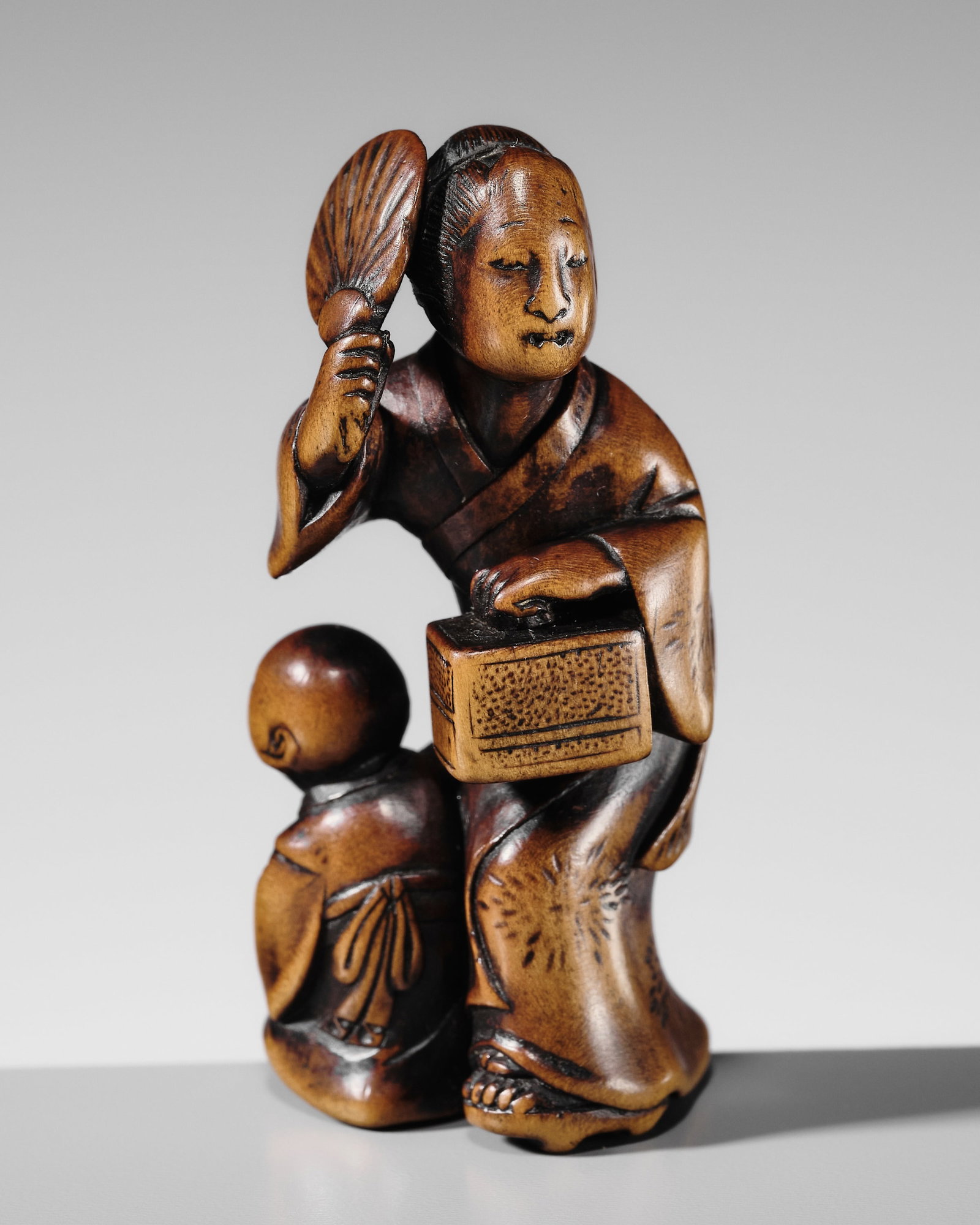 SHUNKOSAI: A WOOD NETSUKE OF A MOTHER WITH CHILD (1 of 13)