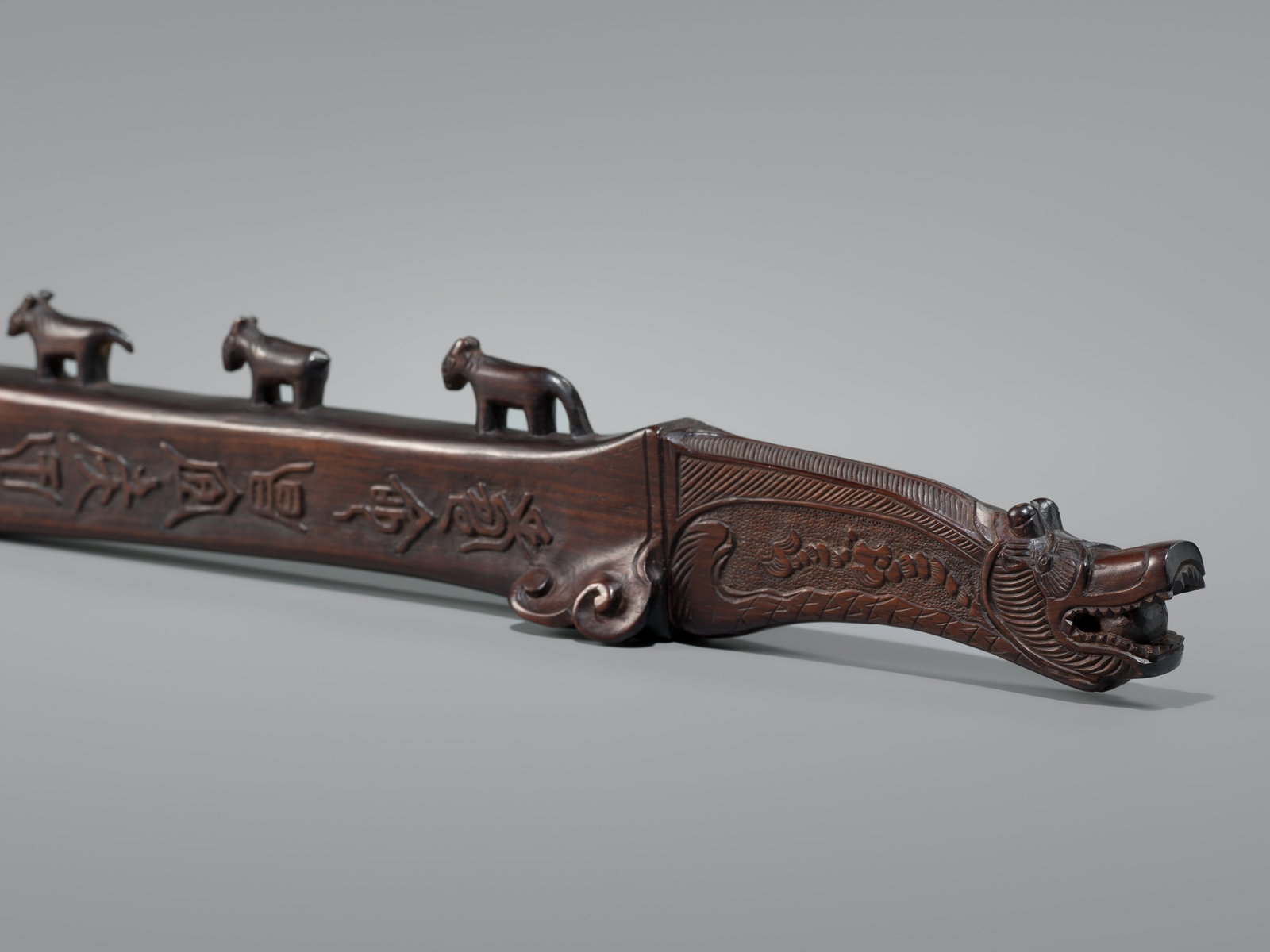 AN UNUSUAL AND AUSPICIOUS HARDWOOD BOKUTO (DOCTOR'S SWORD) WITH A DRAGON-FISH HEAD: AN UNUSUAL AND AUSPICIOUS HARDWOOD BOKUTO (DOCTOR'S SWORD) WITH A DRAGON-FISH HEAD Unsigned Japan, 19th century, Edo period (1615-1868) Boldly carved, the blade rising to a high tip, decorated to the 