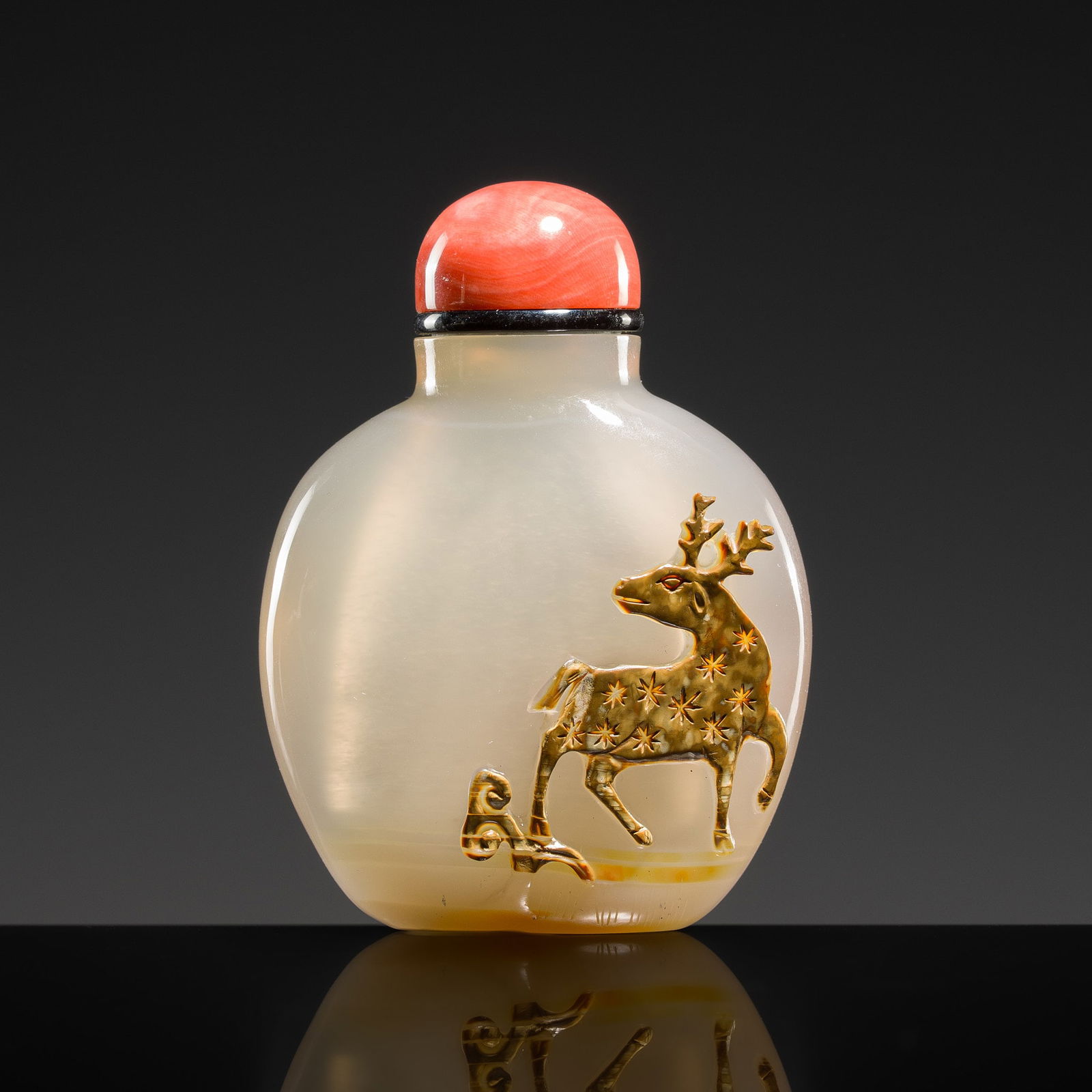 A CAMEO AGATE 'DEER AND HORSE' SNUFF BOTTLE, 1750-1850: A CAMEO AGATE 'DEER AND HORSE' SNUFF BOTTLE, 1750-1850 China. The flattened ovoid body supported on a recessed foot and surmounted by a cylindrical neck with flat mouth. The sides finely carved in rel