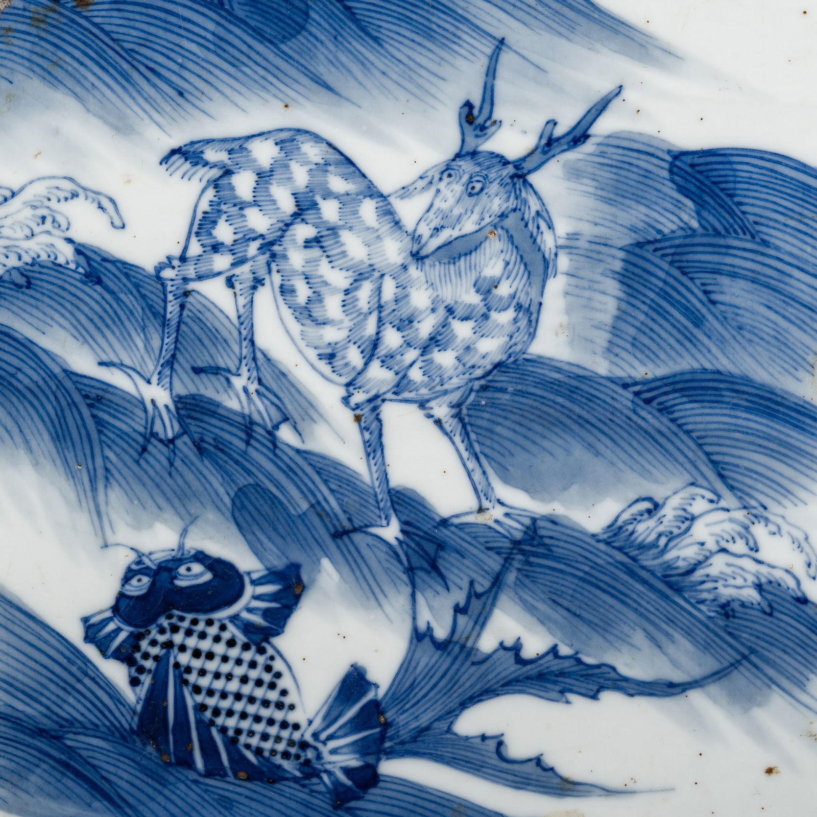 AN UNUSUAL BLUE AND WHITE PORCELAIN TILE WITH MYTHICAL BEAST AND CARP, 16TH - 17TH CENTURY: AN UNUSUAL BLUE AND WHITE PORCELAIN TILE WITH MYTHICAL BEAST AND CARP, 16TH - 17TH CENTURY Published: Porcelaines Chinoises dans un manoir normand, une Histoire des Bleu et Blanc, Alain Saint-Loubert-