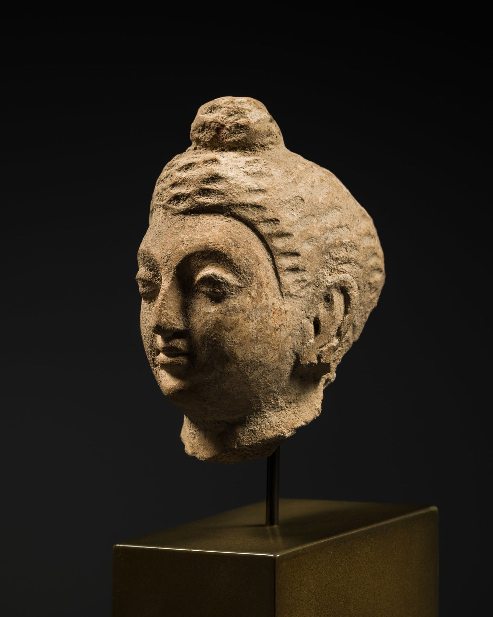 A SMALL STUCCO HEAD OF BUDDHA SHAKYAMUNI, ANCIENT REGION OF GANDHARA, 3RD-4TH CENTURY (1 of 12)