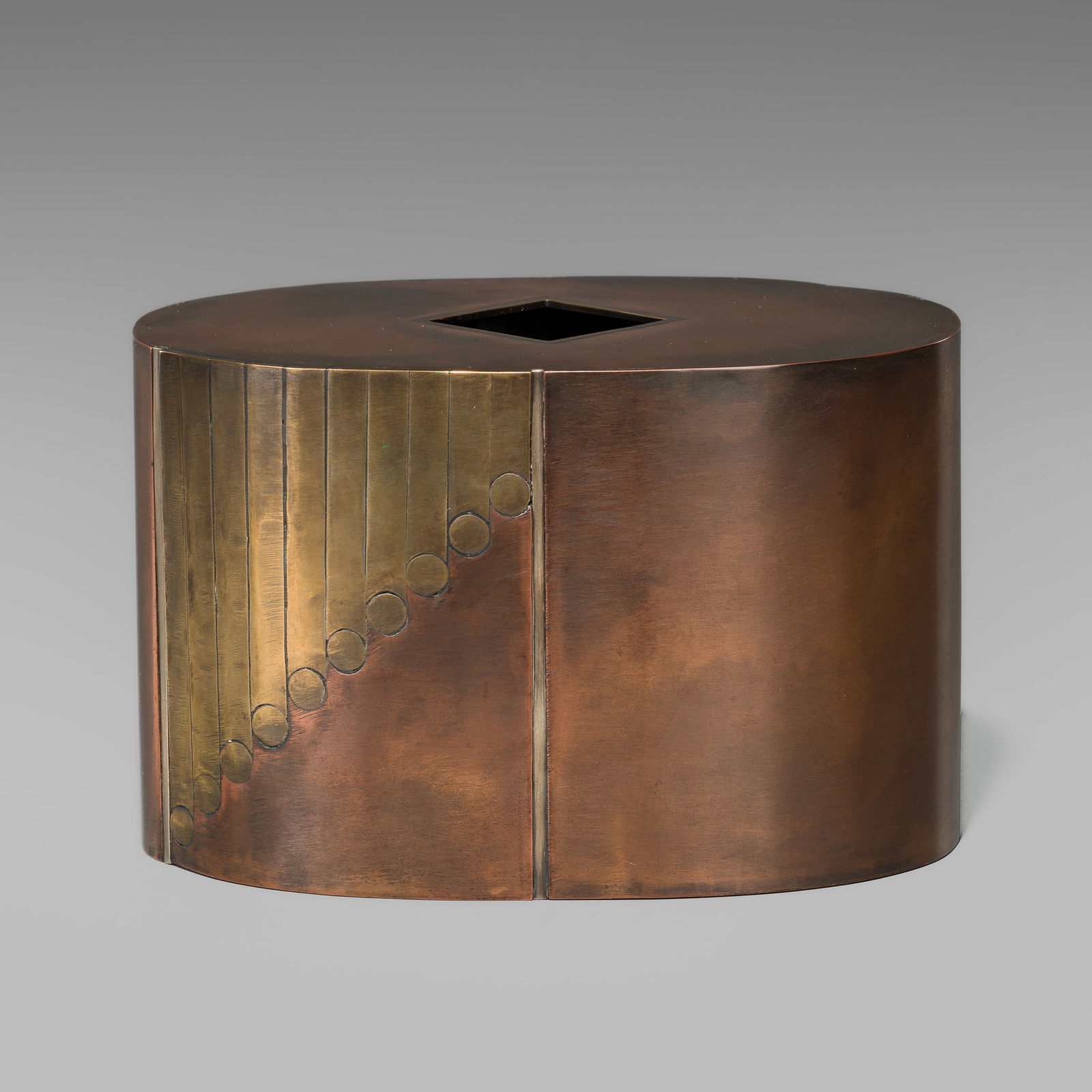 SHIGERU: AN INLAID COPPER FLOWER VASE: SHIGERU: AN INLAID COPPER FLOWER VASE By Shigeru, signed Shigeru 茂 Japan, 20th centuryThe vase, of oval section and rising from a flat foot to a flat top with a small square mouth, highly pol