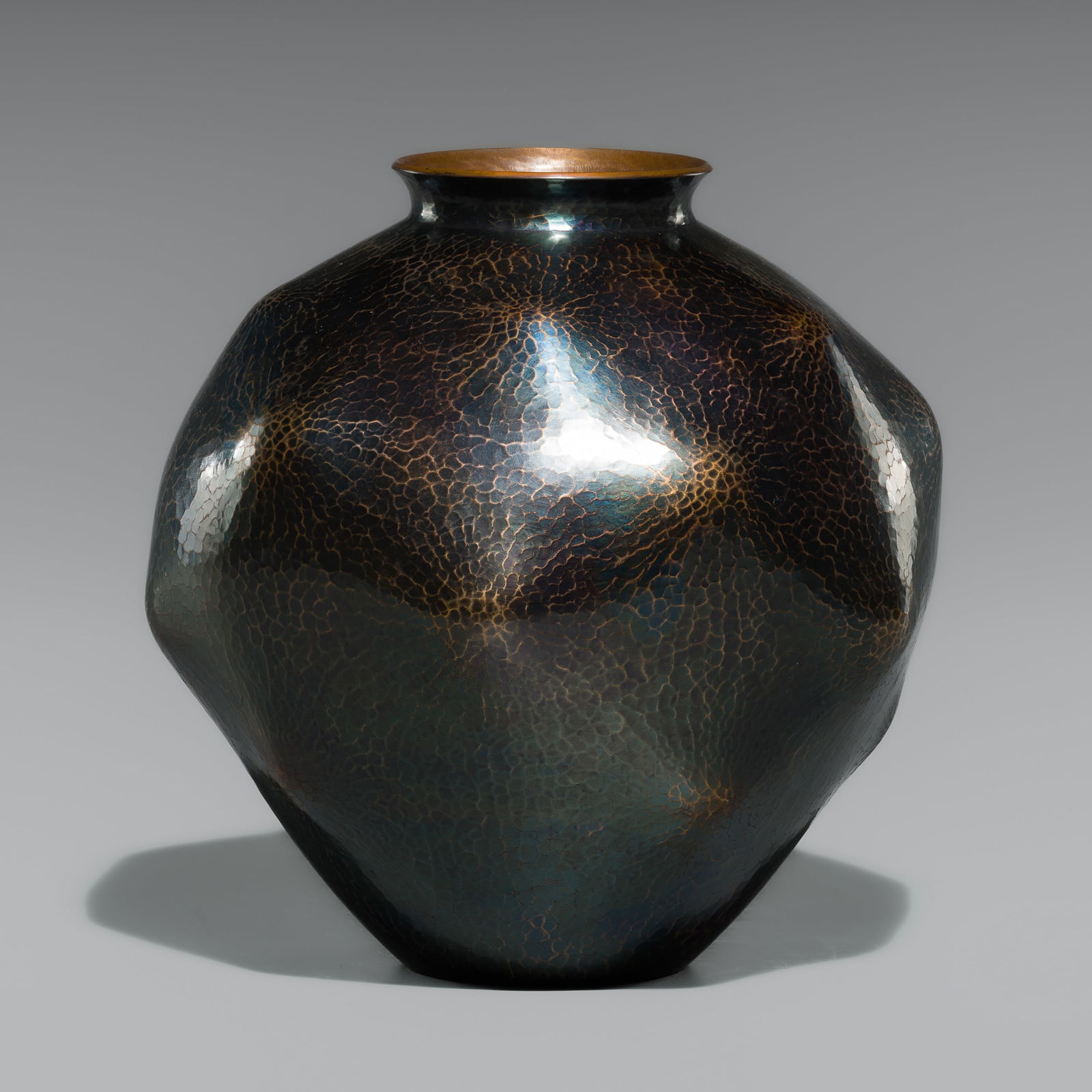 GYOKUSENDO: A HAMMERED SUAKA (COPPER) VASE: GYOKUSENDO: A HAMMERED SUAKA (COPPER) VASE By the Gyokusendo workshop, signed Gyokusendo Japan, Showa period (1926-1989)Of broad ovoid form with subtly faceted contours, the shoulders sloping gently t