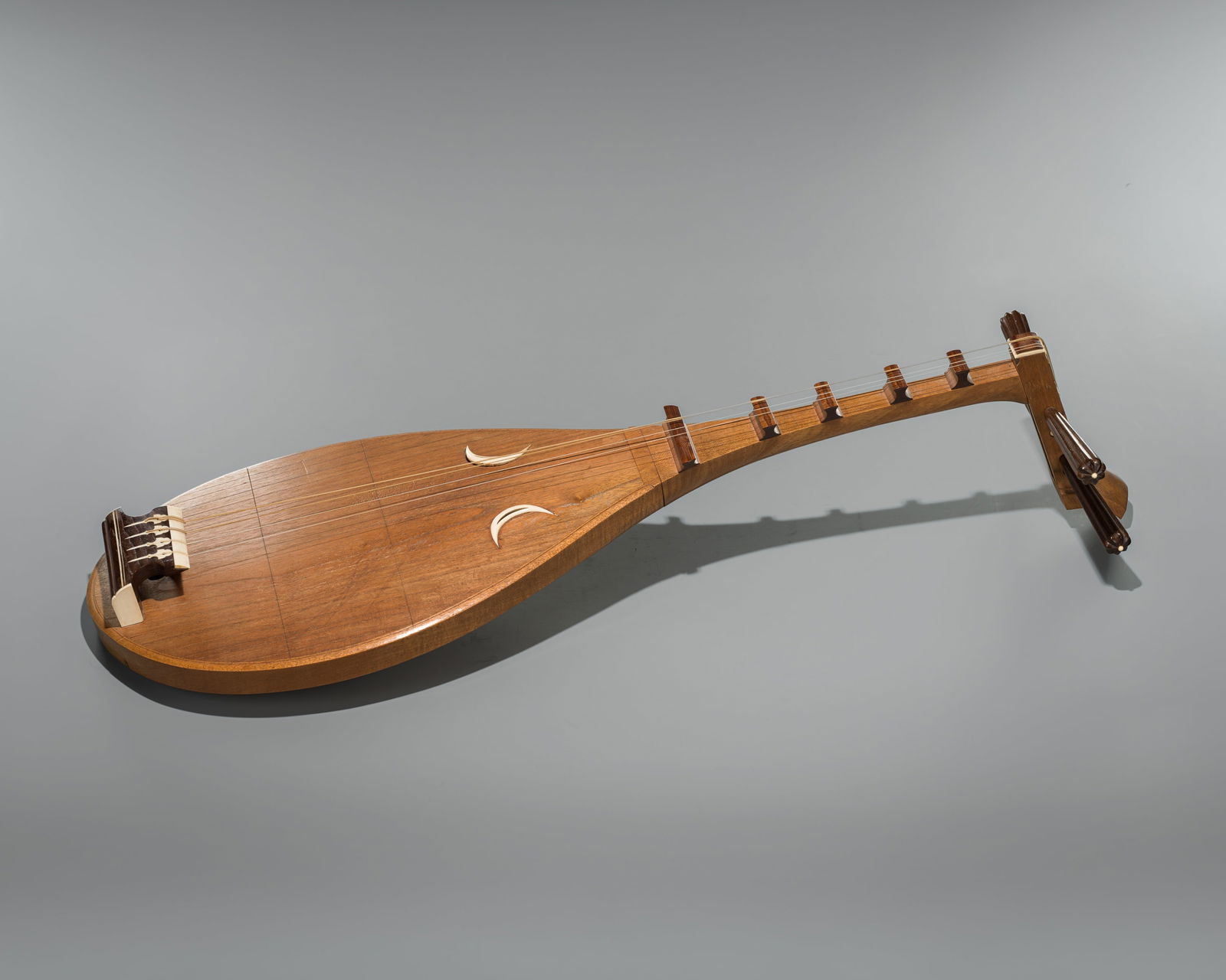 A JAPANESE BIWA, TRADITIONAL LUTE INSTRUMENT: A JAPANESE BIWA, TRADITIONAL LUTE INSTRUMENT Japan, Taisho period (1912-1926)The 4-string biwa features a pear-shaped wooden body with a smooth, polished finish that highlights the fine grain of the w