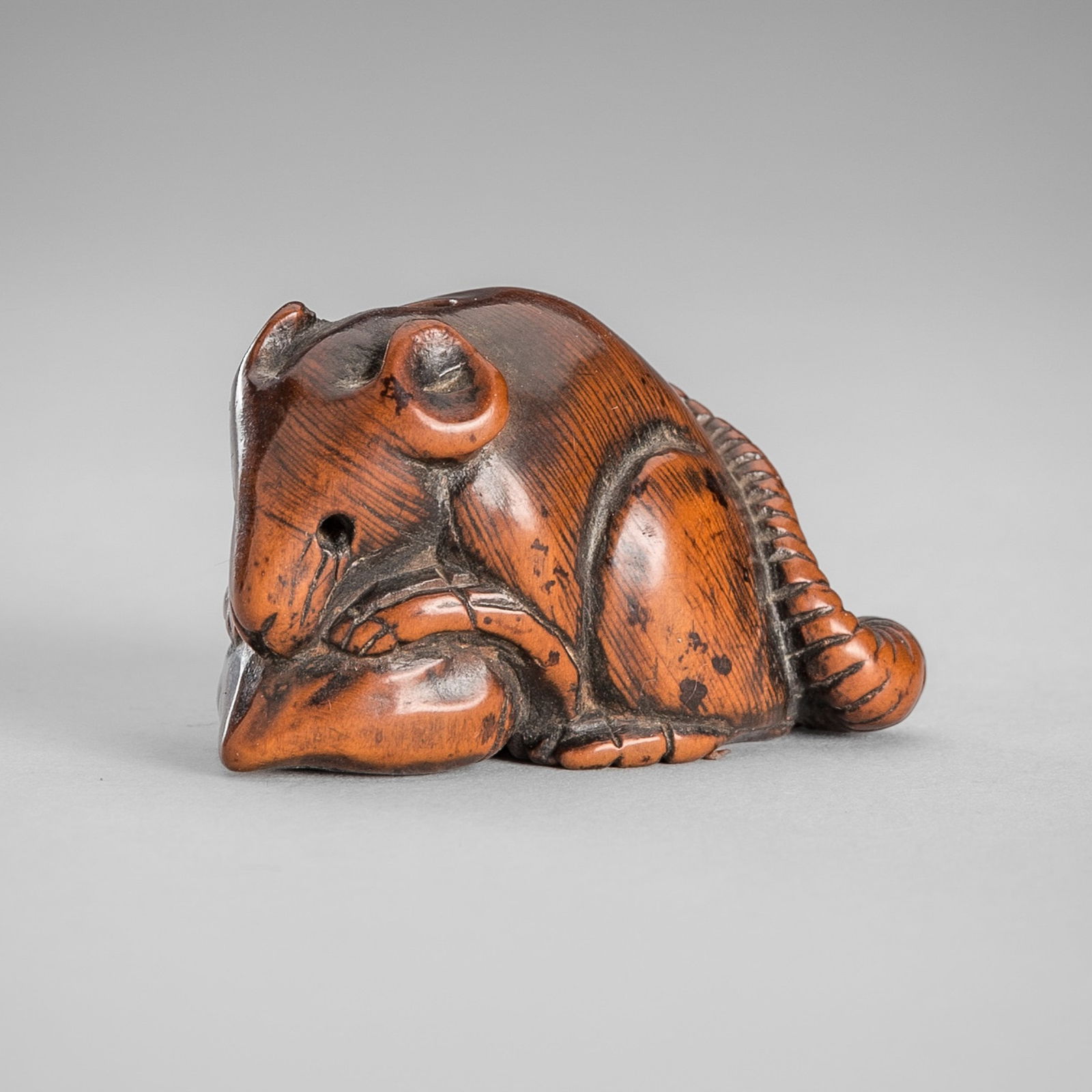 YOSHITOMO: A FINE WOOD NETSUKE OF A RAT EATING A CHESTNUT (1 of 12)