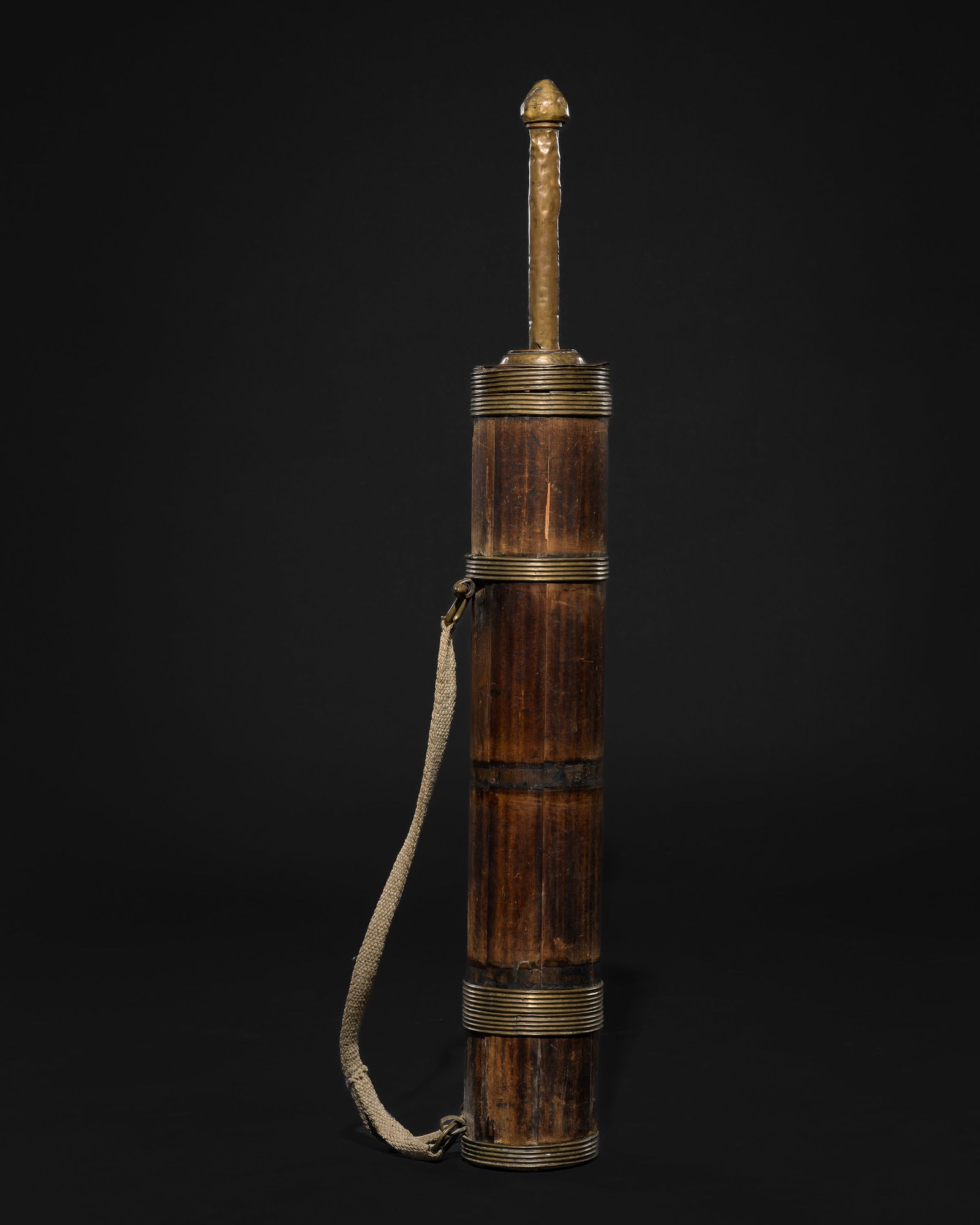 A WOOD AND BRASS BUTTER TEA MAKER (CHANGDUNG): A WOOD AND BRASS BUTTER TEA MAKER (CHANGDUNG) Northeastern India or Tibet, 19th century. The cylindrical container, constructed from multiple sections of curved wood, mounted with striated brass fitti