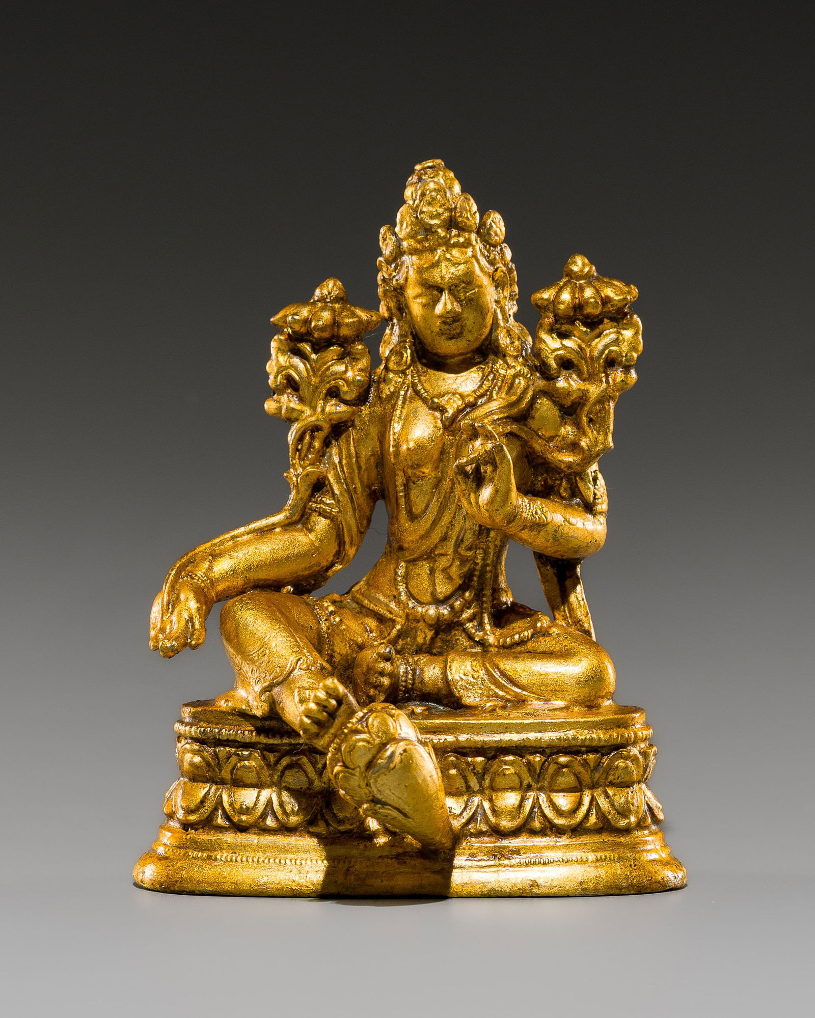 A GILT-BRONZE FIGURE OF GREEN TARA, ZANABAZAR SCHOOL: A GILT-BRONZE FIGURE OF GREEN TARA, ZANABAZAR SCHOOL Mongolia, 18th-19th century. Finely cast, seated in lalitasana on a double-lotus pedestal with finely beaded rims, with her right foot resting on a