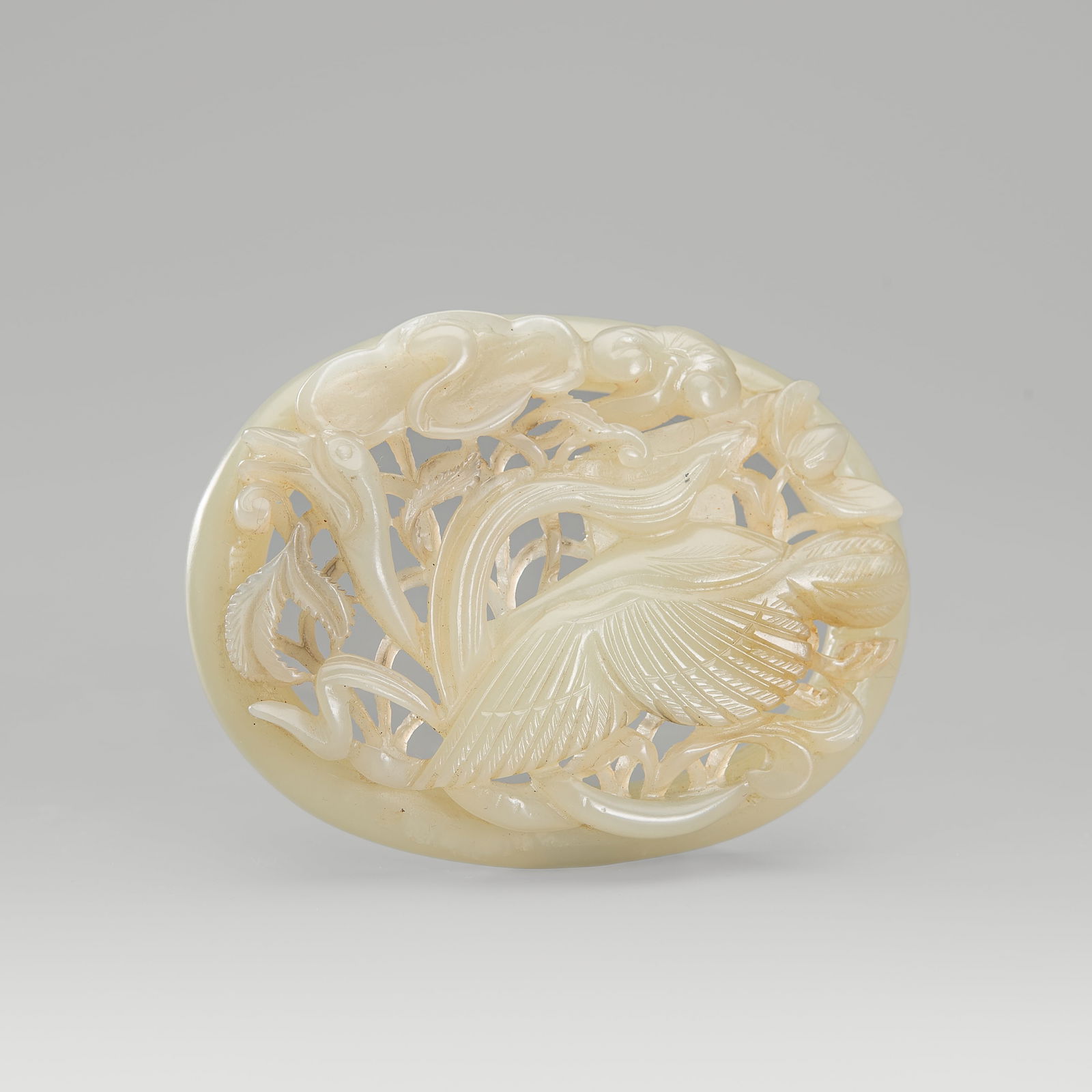 A PALE CELADON JADE OPENWORK 'SPRING WATER' OVAL PLAQUE, c. 1900s: A PALE CELADON JADE OPENWORK 'SPRING WATER' OVAL PLAQUE, c. 1900s China, late Qing Dynasty (1644-1912) to Republic period (1912-1949). Of oval form, intricately carved in openwork and in layered relie