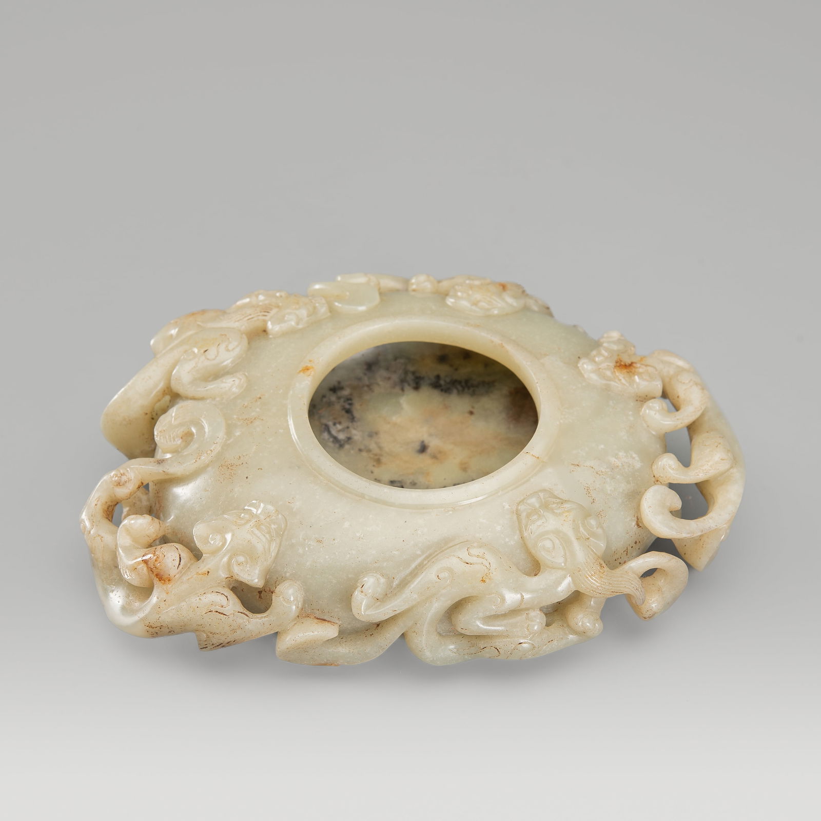 A FINE PALE CELADON JADE 'CHILONG' BRUSH WASHER, c. 1900s: A FINE PALE CELADON JADE 'CHILONG' BRUSH WASHER, c. 1900s China, late Qing Dynasty (1644-1912) to Republic period (1912-1949). Of oval form and lenticular section, with a slightly raised rim, the exte