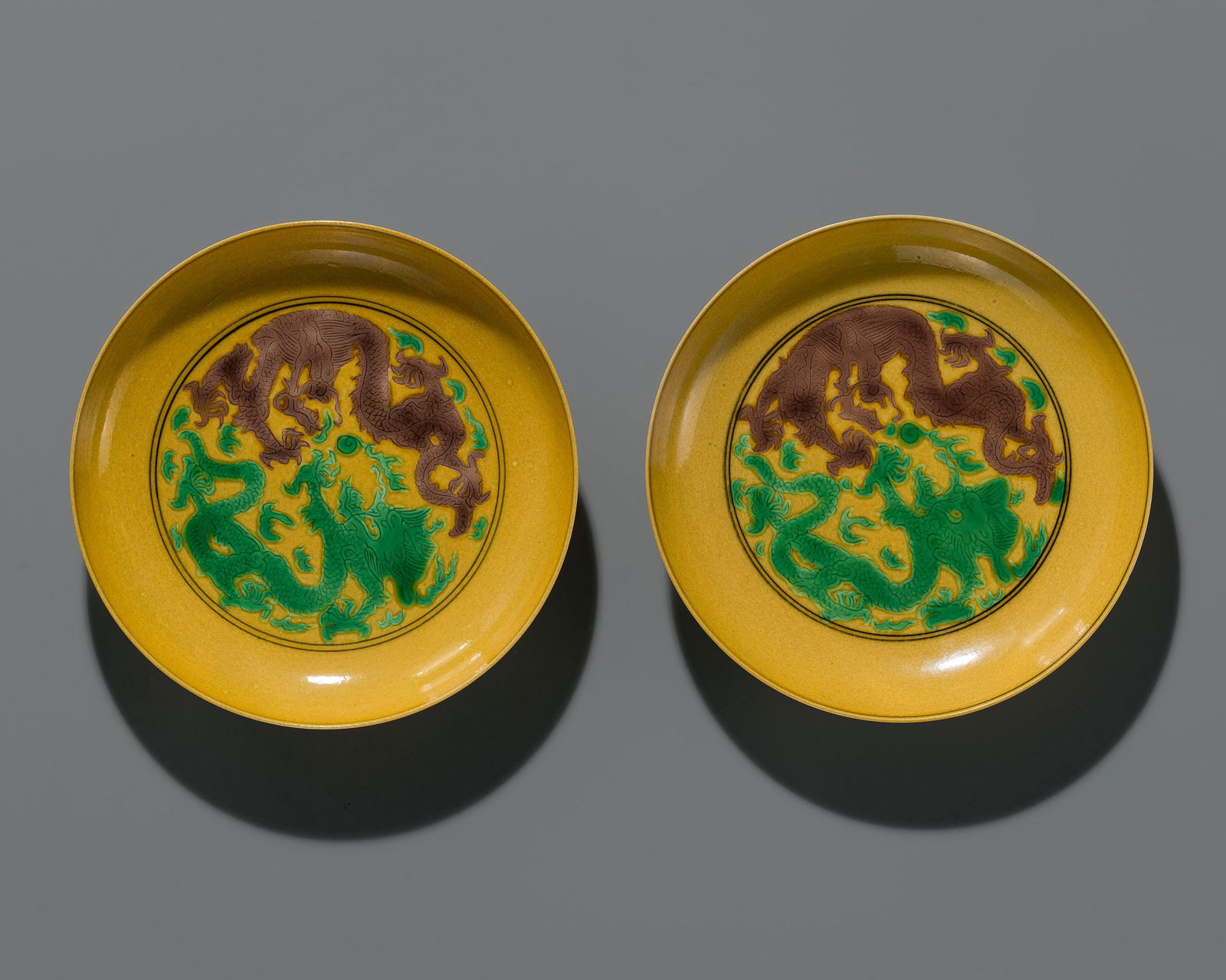 A PAIR OF YELLOW-GROUND GREEN AND AUBERGINE-ENAMELED 'DRAGON' DISHES, JIAQING MARK AND PERIOD (1 of 8)