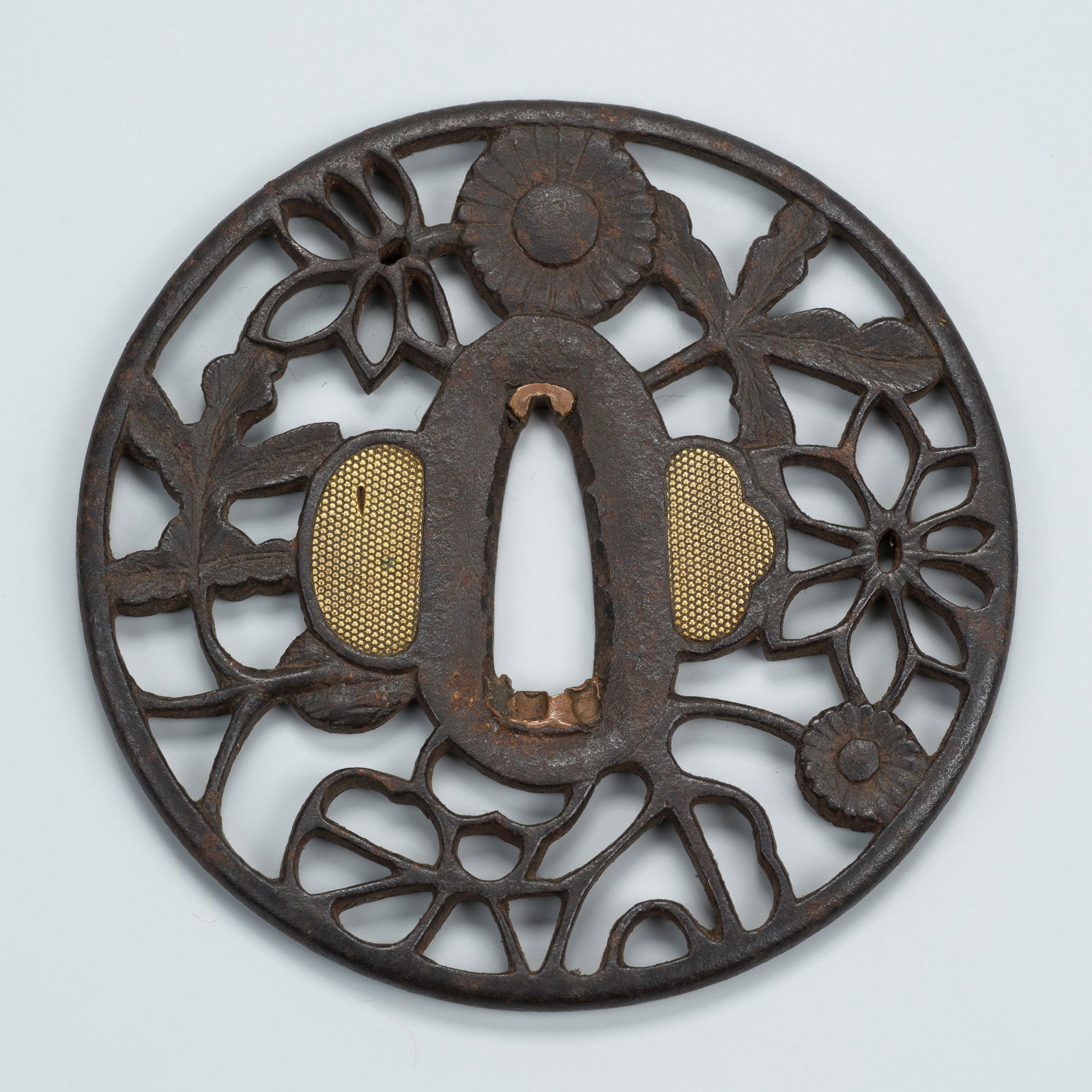 AN IRON SUKASHI TSUBA WITH FLORAL AND FOLIAGE MOTIFS (1 of 6)