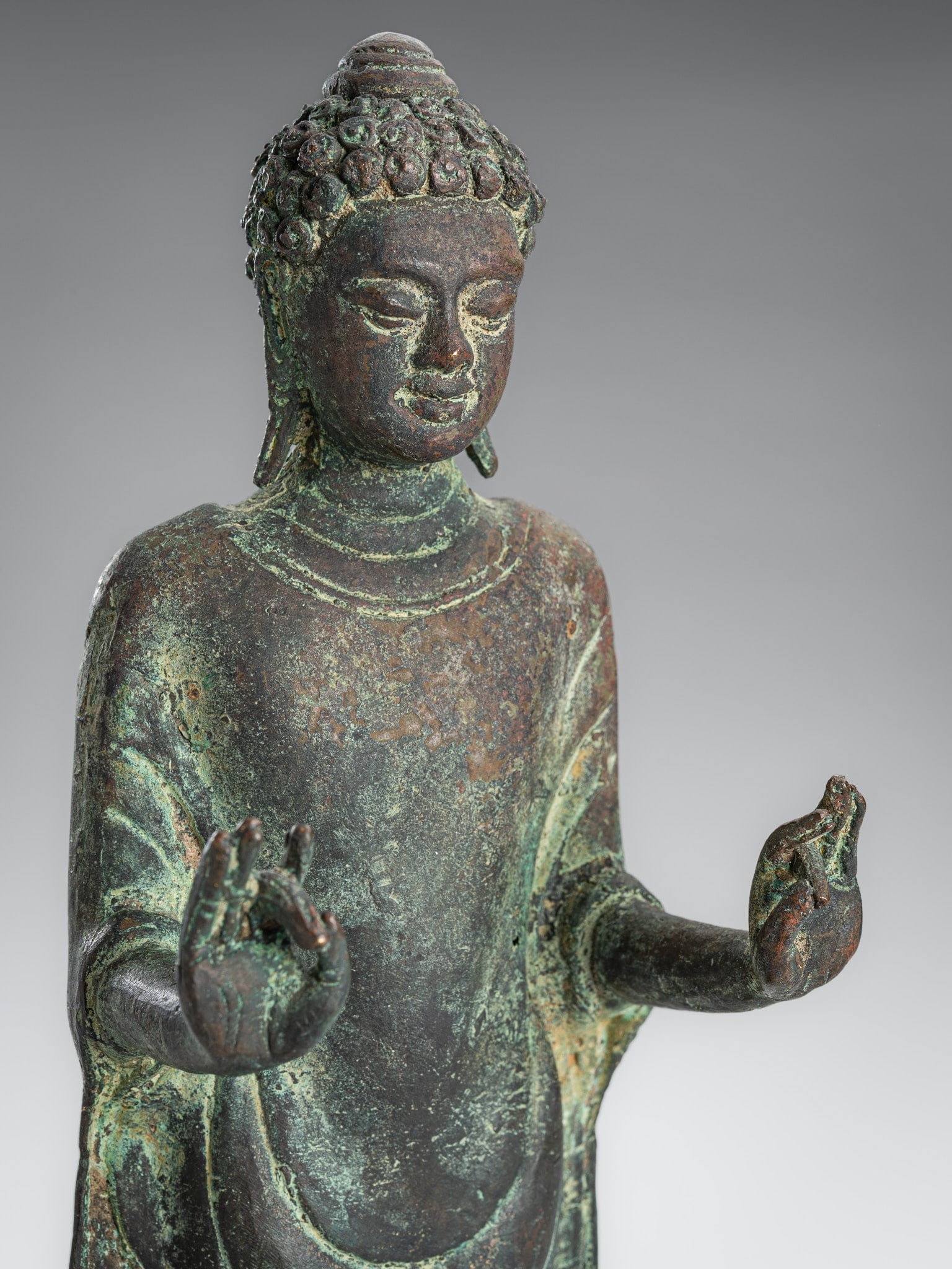 A COPPER ALLOY FIGURE OF A STANDING BUDDHA, JAVA, 9TH-10TH CENTURY (1 of 13)