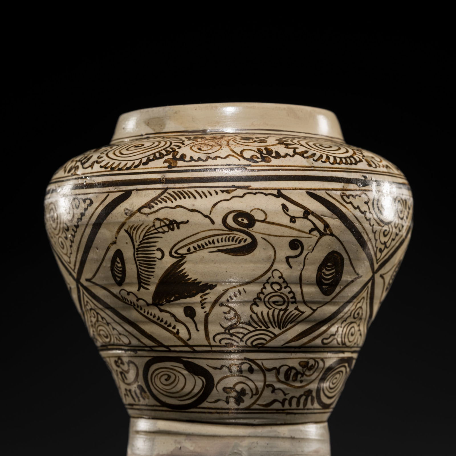 A FINE CIZHOU PAINTED POTTERY VASE, JIN-YUAN DYNASTY: A FINE CIZHOU PAINTED POTTERY VASE, JIN-YUAN DYNASTY China, 1115-1368. Well potted, of baluster form rising from a recessed base to a short neck, painted in black-to-brown slip on a cream ground, wit