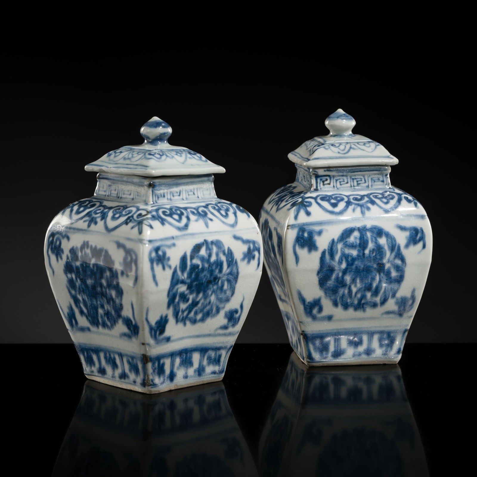 A PAIR OF BLUE AND WHITE SQUARE BALUSTER VASES AND COVERS, FOUR-CHARACTER MARK, MING DYNASTY: A PAIR OF BLUE AND WHITE SQUARE BALUSTER VASES AND COVERS, FOUR-CHARACTER MARK, MING DYNASTY China, 16th century. Of square baluster form, rising to a straight neck and lipped rim, the exteri