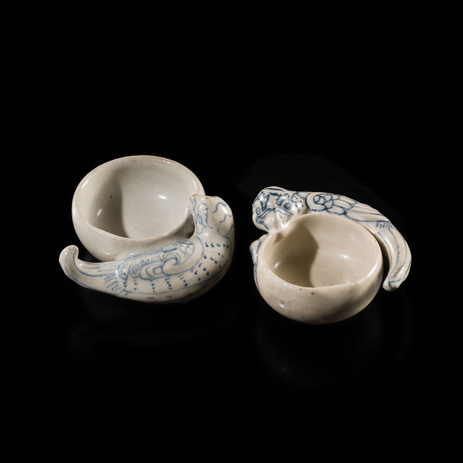 A PAIR OF RARE BLUE AND WHITE STONEWARE BRUSH WASHERS, LÊ DYNASTY, 15TH CENTURY, FROM THE HOI: A PAIR OF RARE BLUE AND WHITE STONEWARE BRUSH WASHERS, LÊ DYNASTY, 15TH CENTURY, FROM THE HOI AN HOARD Vietnam, Hai Duong province, Chu Dau kilns. Each well-modeled as a parrot, with its tail ge