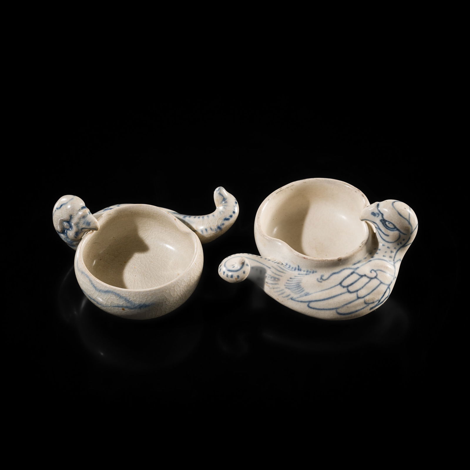 A PAIR OF BLUE AND WHITE 'PARROT' BRUSHWASHERS, FROM THE HOI AN CARGO: A PAIR OF BLUE AND WHITE 'PARROT' BRUSHWASHERS, FROM THE HOI AN CARGO Vietnam, Annam, 15th century. Each finely potted with a rounded bowl and a parrot handle, featuring a curling tail and raised hea