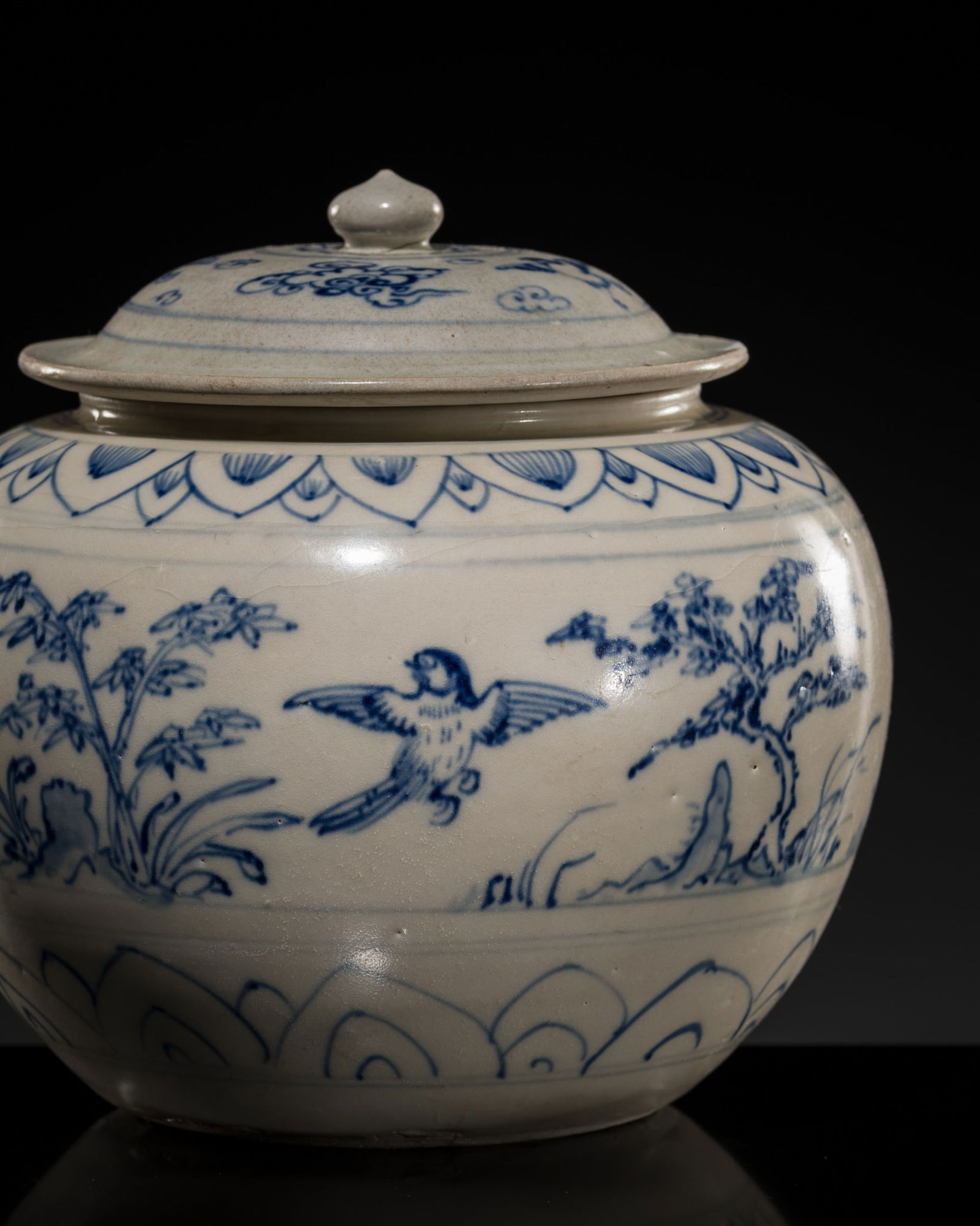 A BLUE AND WHITE STONEWARE JAR AND COVER, LÊ DYNASTY, 15TH CENTURY, FROM THE HOI AN HOARD: A BLUE AND WHITE STONEWARE JAR AND COVER, LÊ DYNASTY, 15TH CENTURY, FROM THE HOI AN HOARD Vietnam, Hai Duong province, Chu Dau kilns. Finely potted, of compressed globular form, rising from a ge