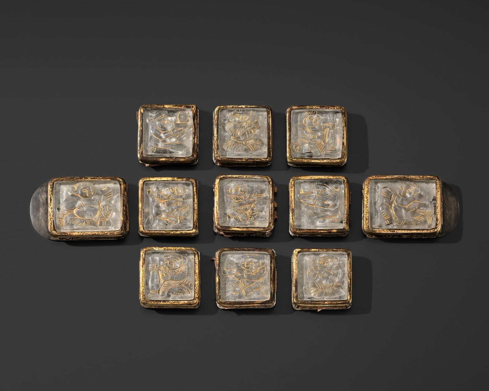 A SET OF ELEVEN ROCK CRYSTAL AND GILT-BRONZE BELT PLAQUES, LIAO DYNASTY: A SET OF ELEVEN ROCK CRYSTAL AND GILT-BRONZE BELT PLAQUES, LIAO DYNASTY Published: Myrna Myers (ed.) & Filippo Salviati (auth.), The Language of Adornment. Chinese Ornaments of Jade