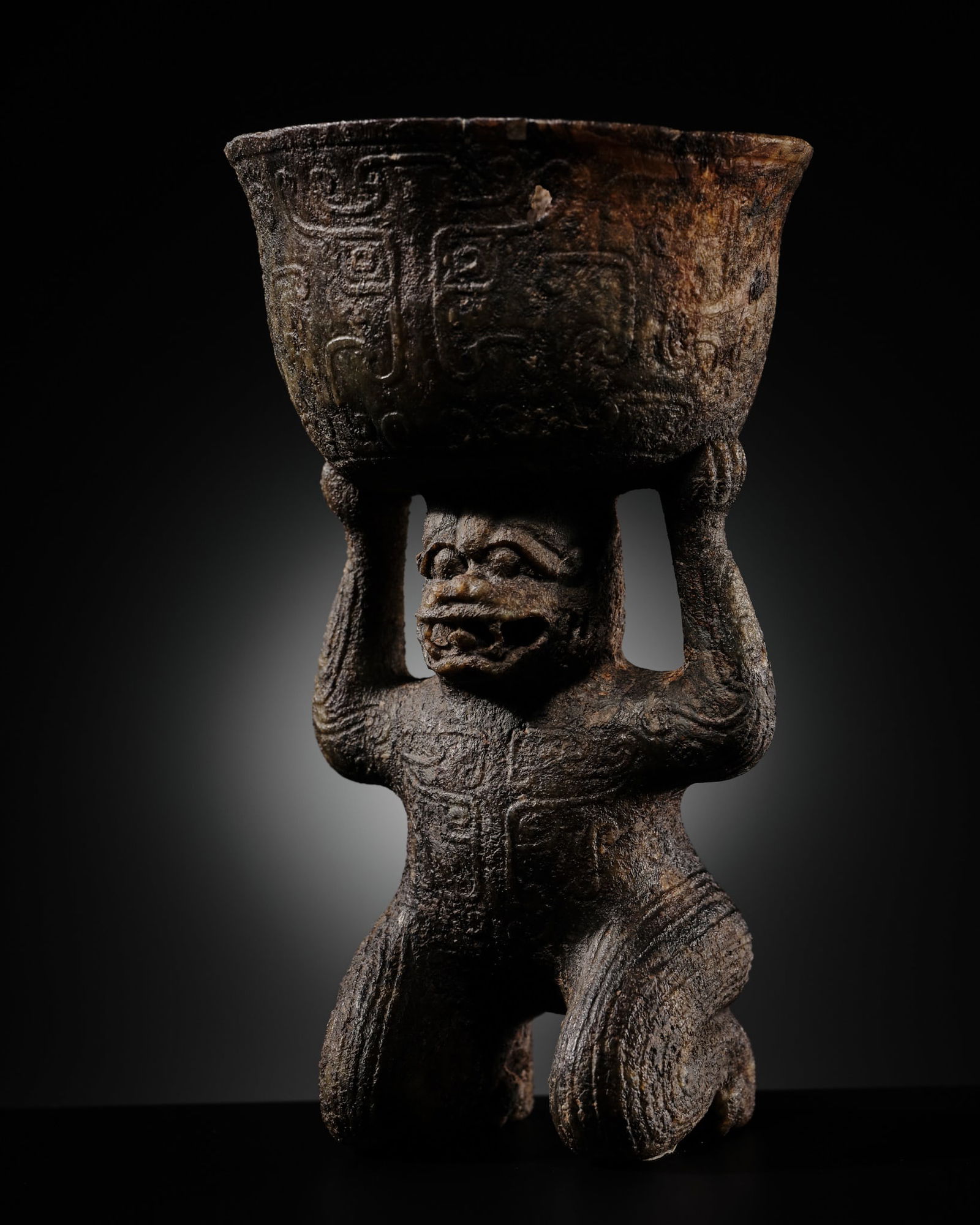 AN EXCEEDINGLY RARE JADE SACRIFICIAL VESSEL IN THE FORM OF A MYTHICAL CREATURE WITH TAOTIE IMAGERY,: AN EXCEEDINGLY RARE JADE SACRIFICIAL VESSEL IN THE FORM OF A MYTHICAL CREATURE WITH TAOTIE IMAGERY, POSSIBLY SHANG TO WESTERN ZHOU DYNASTY China, c. late 2nd to early 1st millennium BC or later. Bold