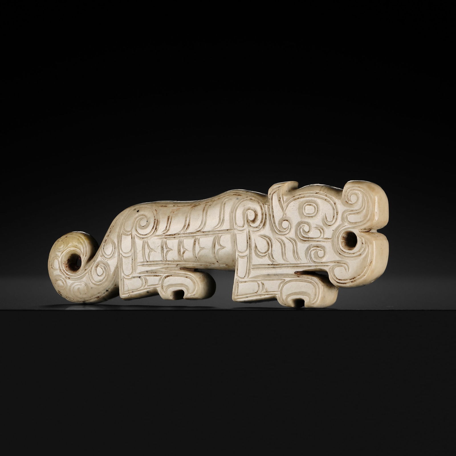 A FINE AND LARGE WHITE JADE 'TIGER' PENDANT, SHANG DYNASTY (1 of 14)