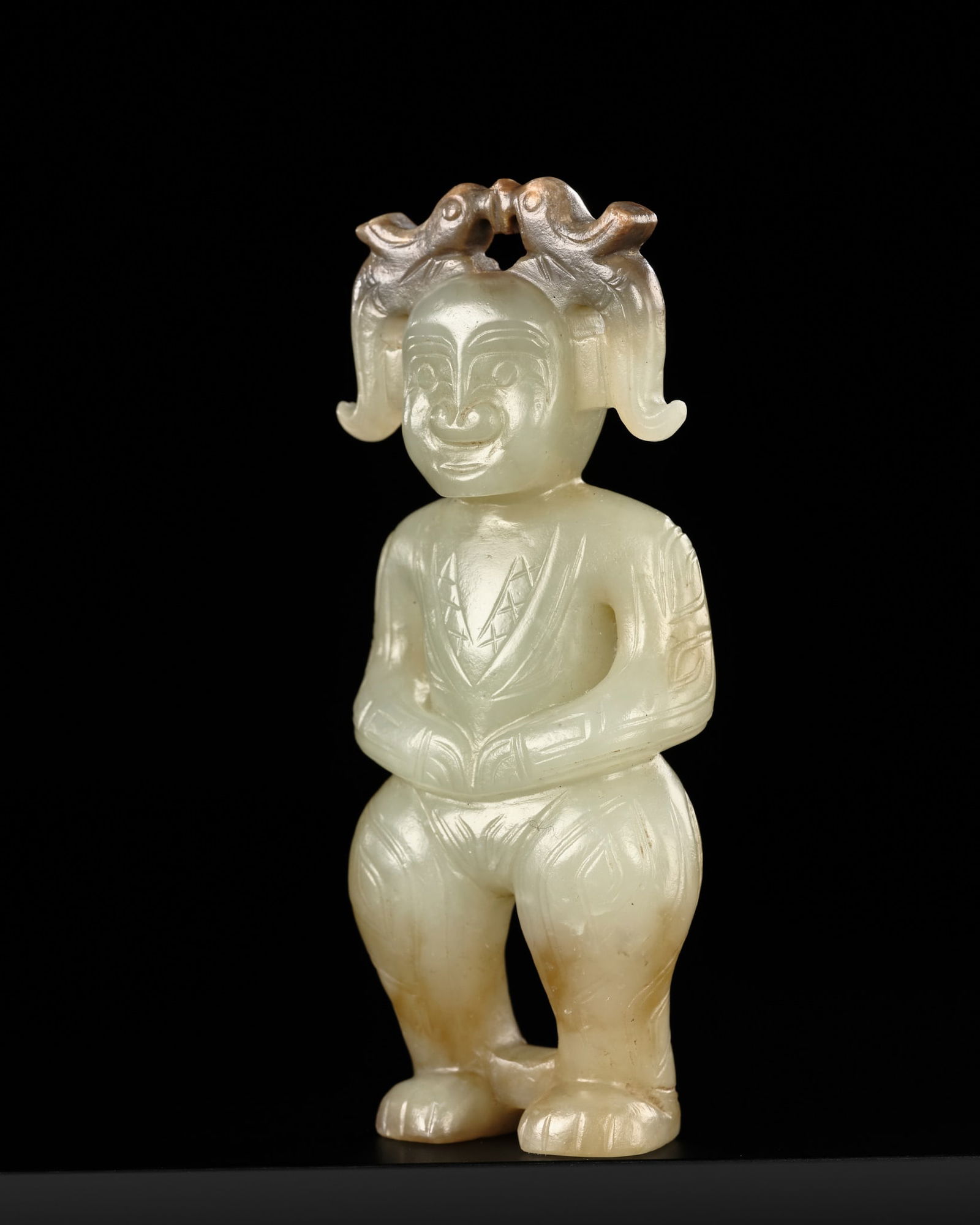 A PALE CELADON AND BROWN JADE STANDING FIGURE, WESTERN ZHOU DYNASTY: A PALE CELADON AND BROWN JADE STANDING FIGURE, WESTERN ZHOU DYNASTY Published: Jean-Paul Desroches (ed.) et al, The Beginning of the World. Dragons, Phoenix and Other Chimera, Fondation