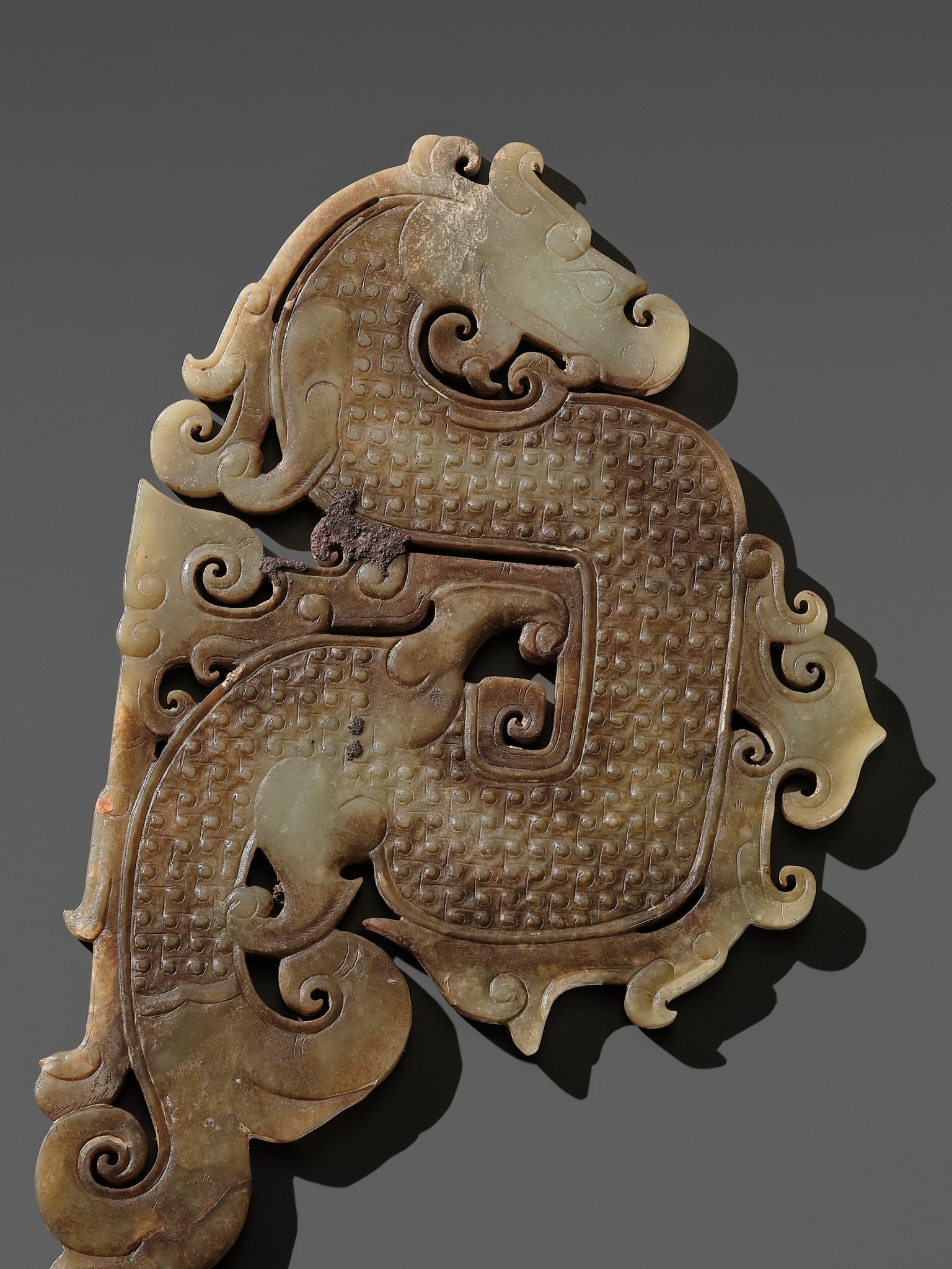A JADE S-FORM DRAGON ORNAMENT, WARRING STATES TO HAN DYNASTY (1 of 14)