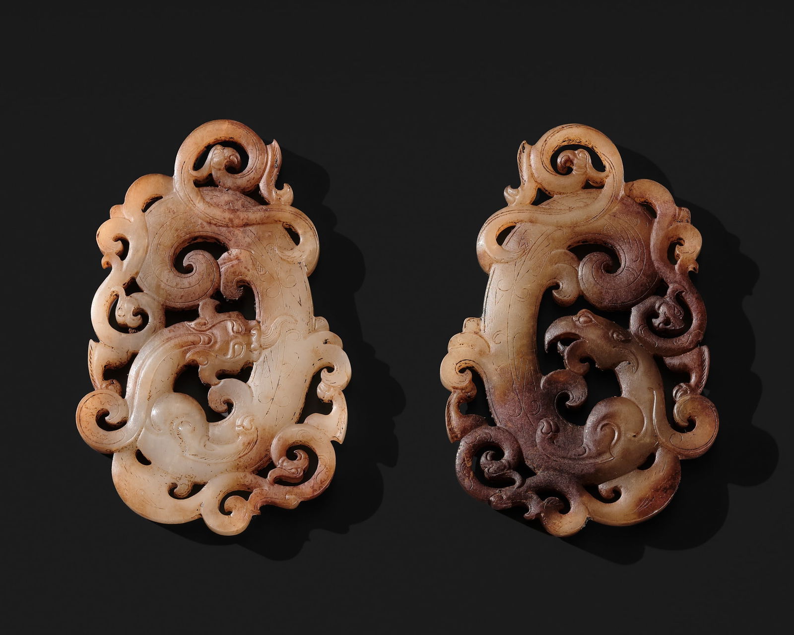 A PAIR OF WHITE AND RUSSET JADE 'CHILONG AND PHOENIX' PENDANTS, PEI, WESTERN HAN DYNASTY (1 of 13)