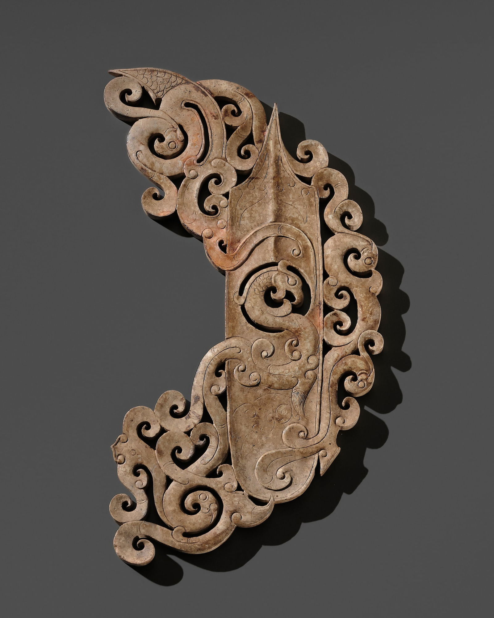 AN OPENWORK GRAY JADE 'ARCHER'S RING' ORNAMENT, HAN DYNASTY: AN OPENWORK GRAY JADE 'ARCHER'S RING' ORNAMENT, HAN DYNASTY Published: Jean-Paul Desroches (ed.) et al, The Beginning of the World. Dragons, Phoenix and Other Chimera, Fondation Baur, G