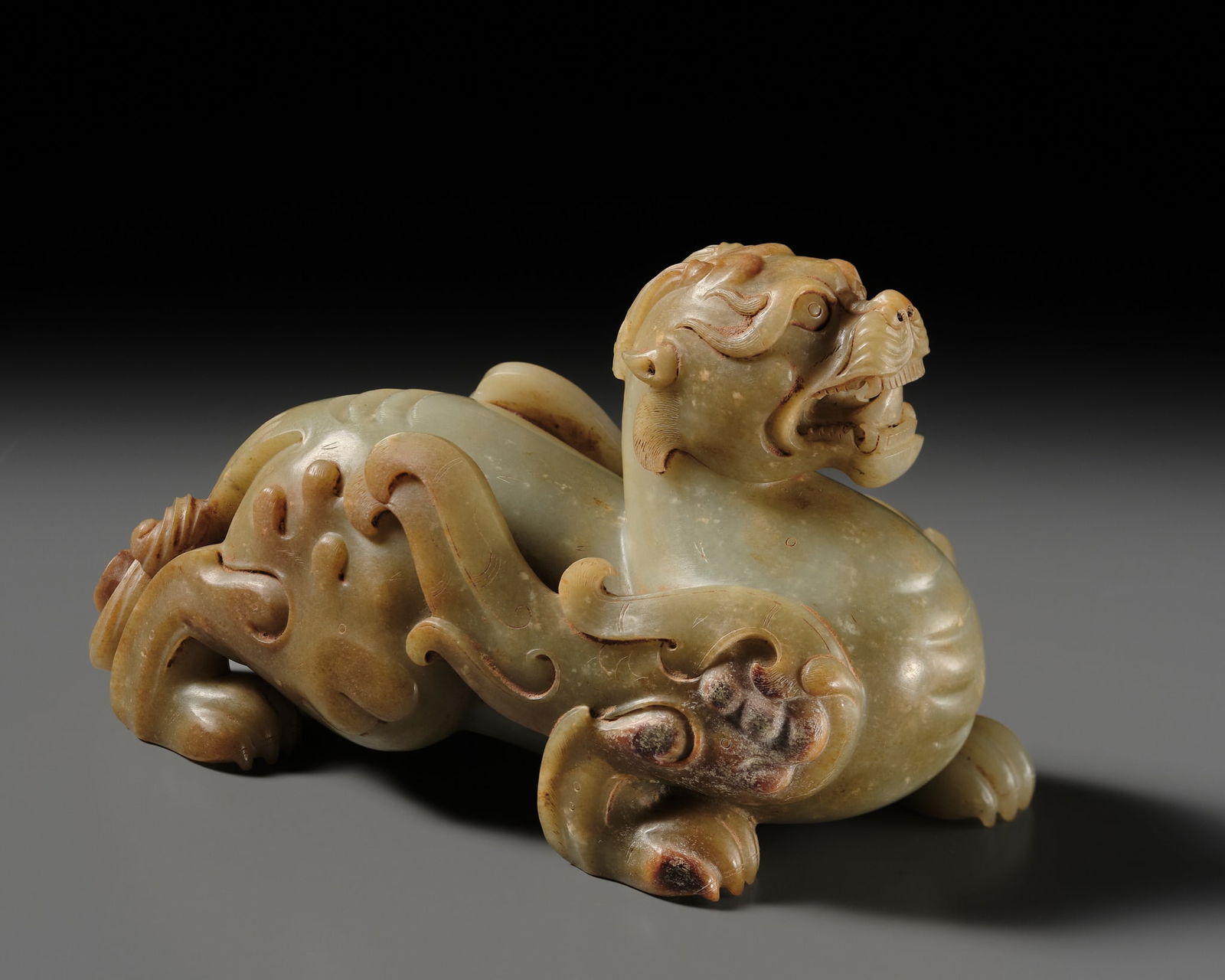 A SUPERB CELADON AND RUSSET JADE FIGURE OF A BIXIE, HAN DYNASTY: A SUPERB CELADON AND RUSSET JADE FIGURE OF A BIXIE, HAN DYNASTY Published: Jean-Paul Desroches (ed.) et al, The Beginning of the World. Dragons, Phoenix and Other Chimera, Fondation Bau