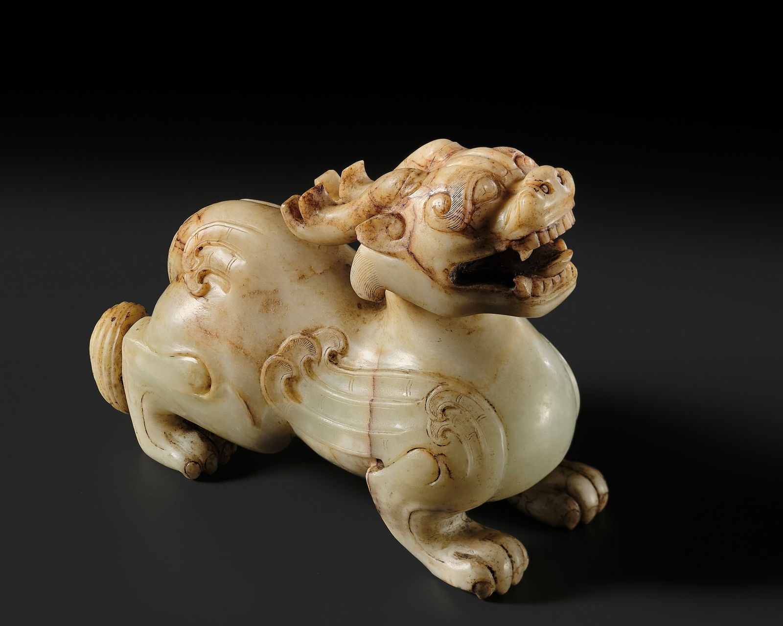 A LARGE CELADON AND RUSSET JADE FIGURE OF A BIXIE, HAN DYNASTY: A LARGE CELADON AND RUSSET JADE FIGURE OF A BIXIE, HAN DYNASTY Published: Jean-Paul Desroches (ed.) et al, The Beginning of the World. Dragons, Phoenix and Other Chimera, Fondation Baur