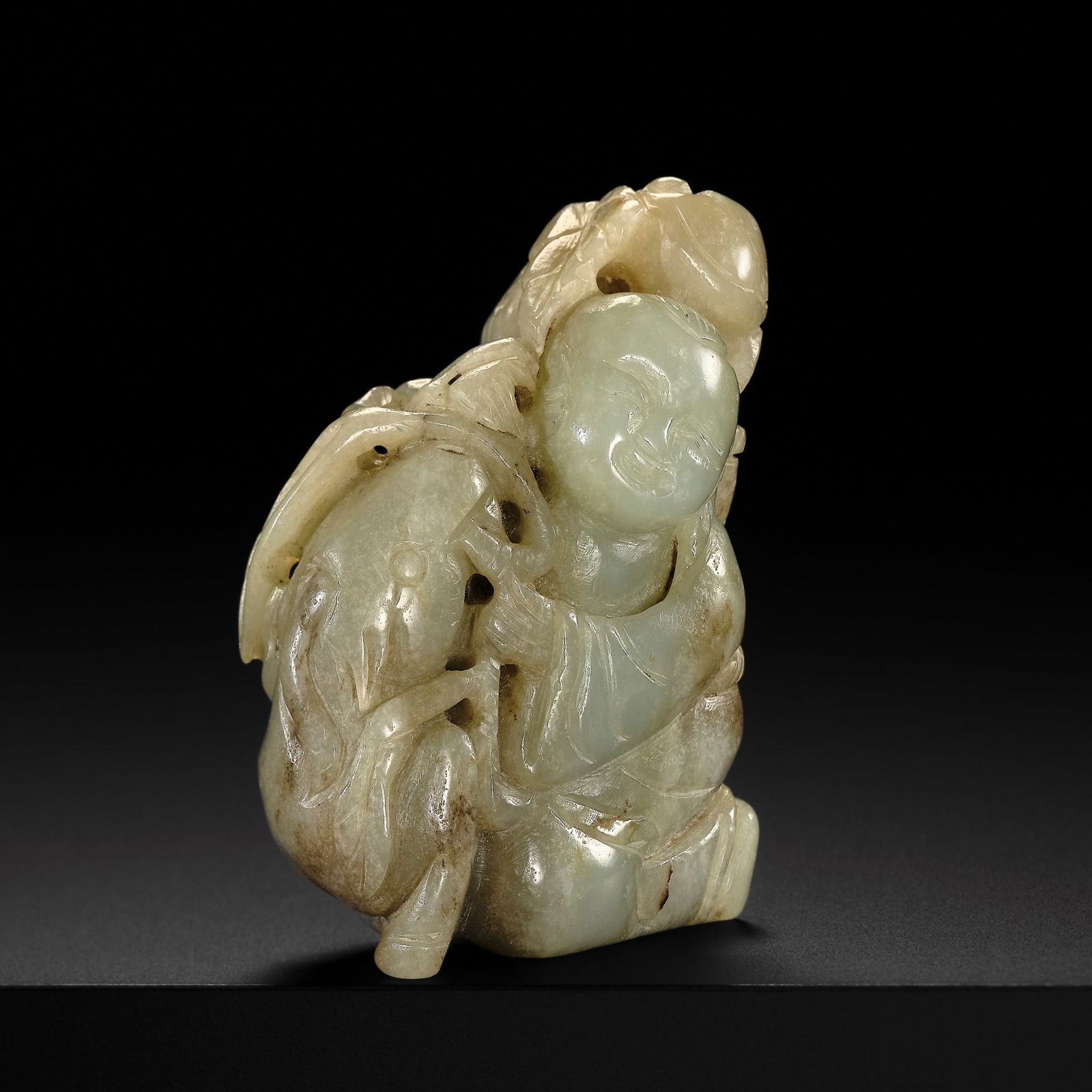 A PALE CELADON JADE FIGURE OF A BOY WITH A SHEEP, EARLY QING DYNASTY: A PALE CELADON JADE FIGURE OF A BOY WITH A SHEEP, EARLY QING DYNASTY China, 17th - 18th century. Finely carved as a kneeling boy beside a recumbent sheep, the youth clad in loose-fitting robe