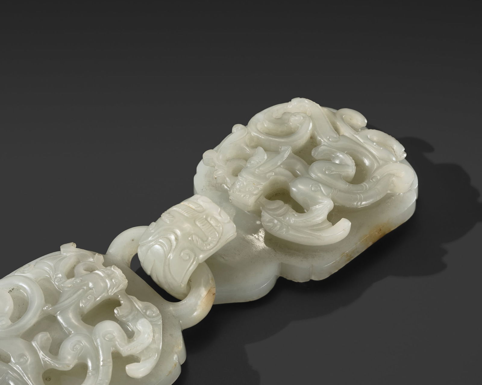 A WHITE JADE 'DRAGON' BELT HOOK AND BUCKLE, QING DYNASTY (1 of 14)