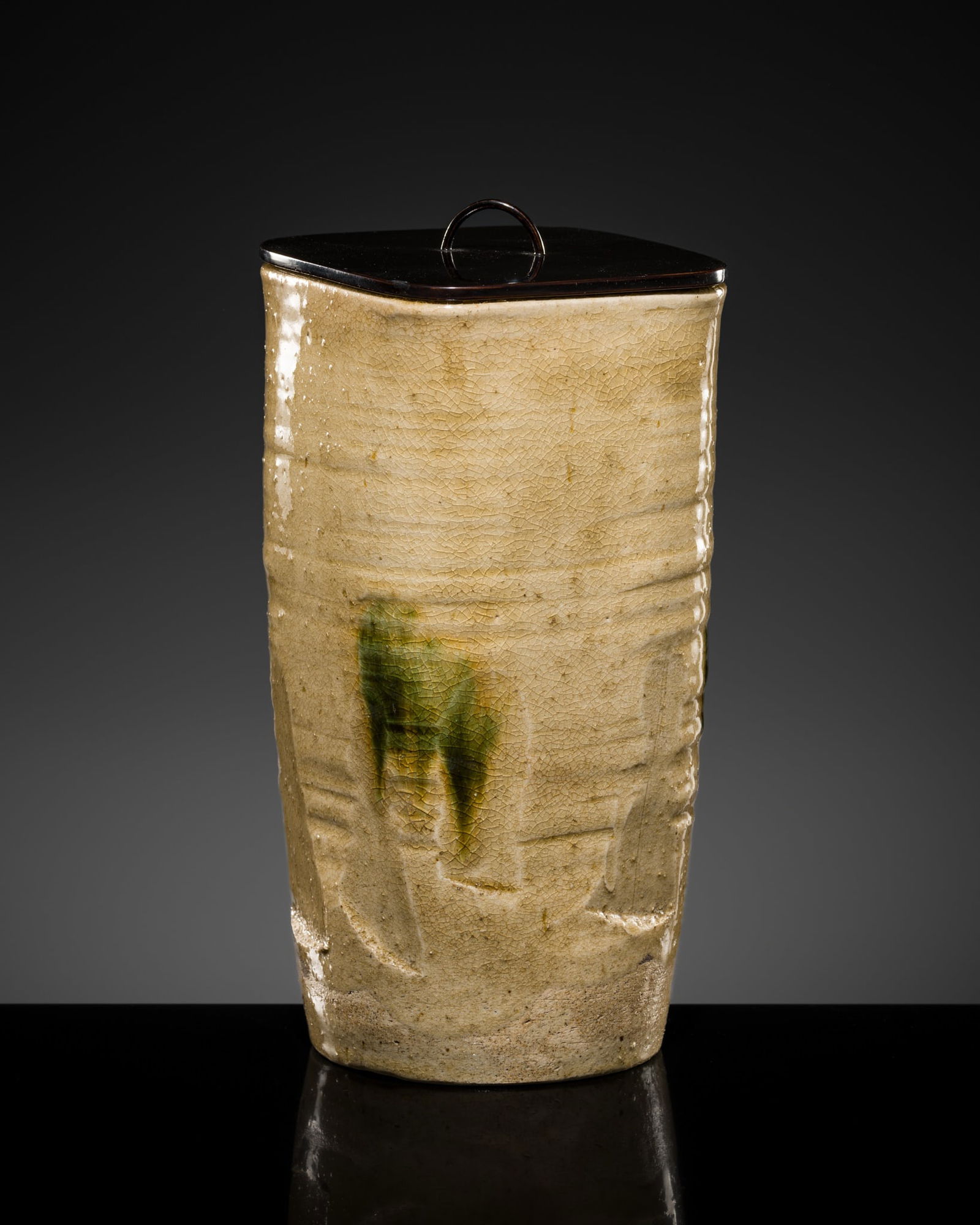A SHIGARAKI MIZUZASHI (WATER JAR), EDO PERIOD: A SHIGARAKI MIZUZASHI (WATER JAR), EDO PERIOD Japan, early 19th century. Heavily potted, of irregular cylindrical form, the stoneware body is covered with a warm beige to pale buff glaze with a fine,