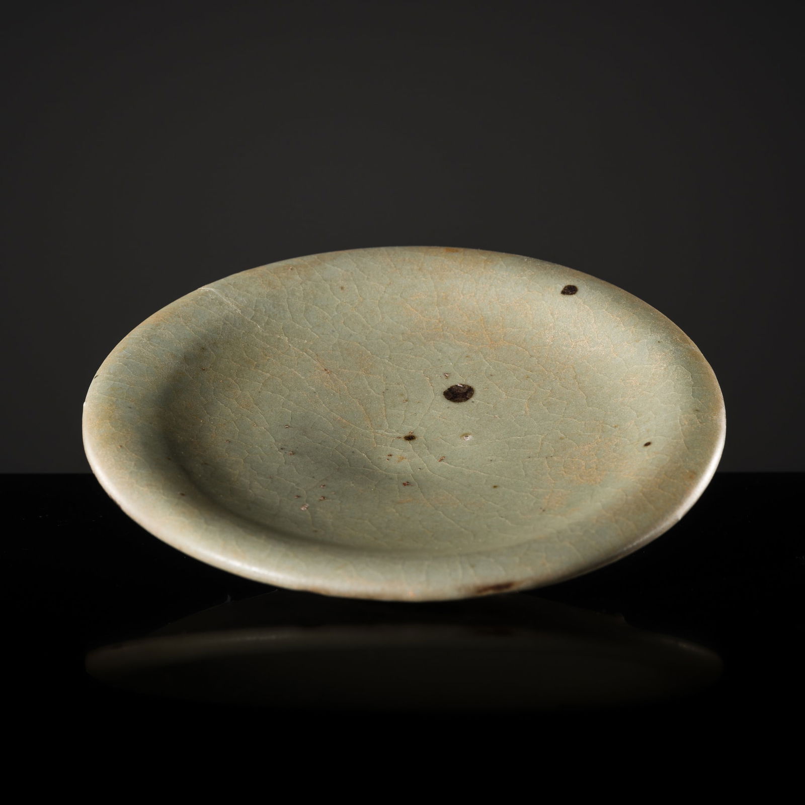 A SMALL JUN DISH, SONG DYNASTY: A SMALL JUN DISH, SONG DYNASTY China, 960-1279. Thickly potted with shallow, rounded sides supported on a circular foot rising to an everted rim, all covered in a rich blueish-green glaze. The foot r