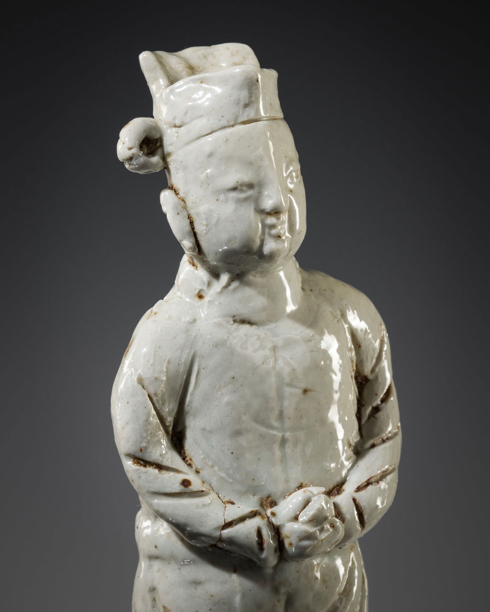 A QINGBAI PORCELAIN FIGURE OF A COURTIER, SOUTHERN SONG TO EARLY MING DYNASTY: A QINGBAI PORCELAIN FIGURE OF A COURTIER, SOUTHERN SONG TO EARLY MING DYNASTY China, c. 13th-14th century. Well-potted, standing upright with a restrained posture, with hands crossed before the