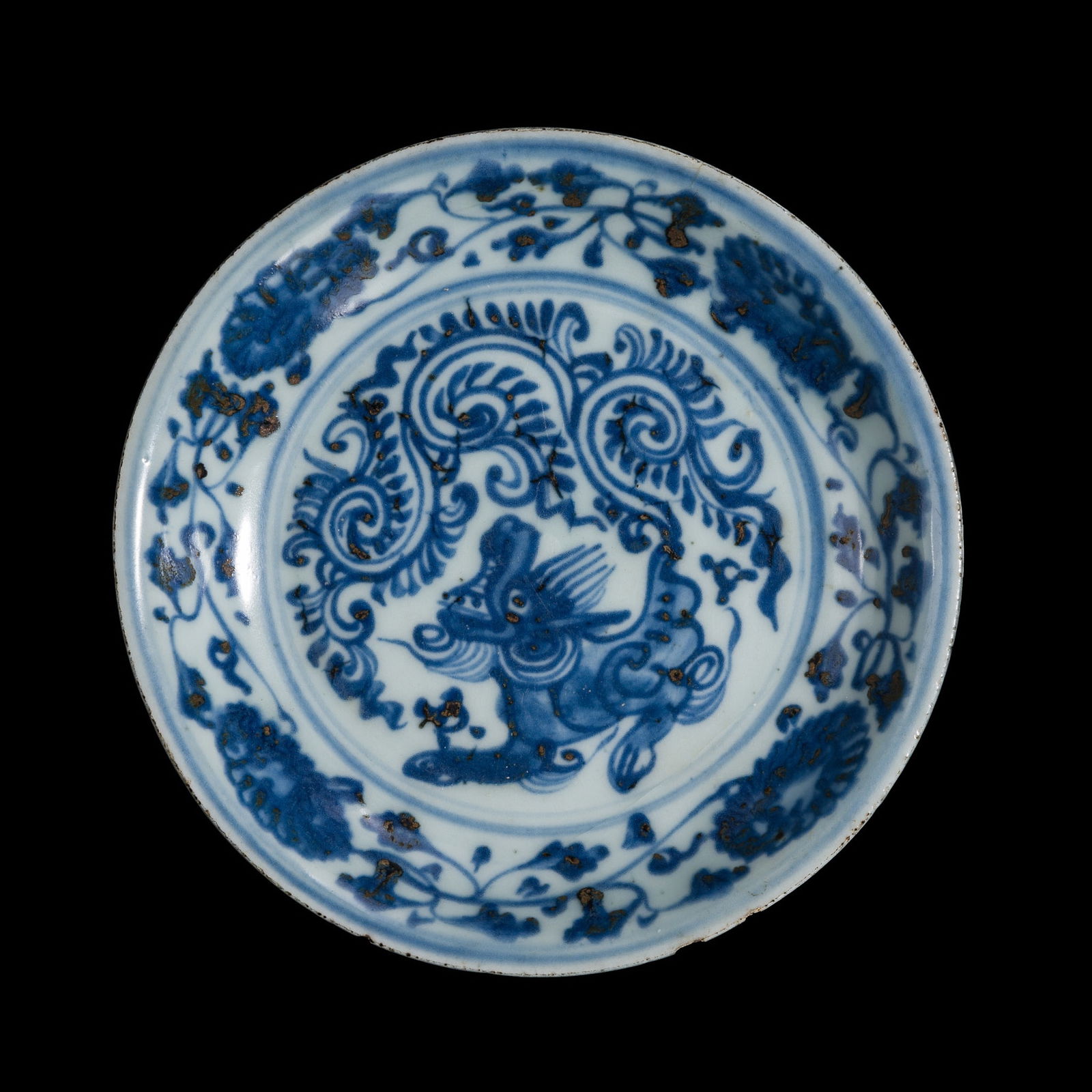 A SMALL BLUE AND WHITE PORCELAIN 'QILIN' DISH, MING DYNASTY, HONGZHI TO ZHENGDE PERIOD: A SMALL BLUE AND WHITE PORCELAIN 'QILIN' DISH, MING DYNASTY, HONGZHI TO ZHENGDE PERIOD China, 1488-1522. The deep, rounded sides supported on a short, tapered foot with a recessed base, rising to
