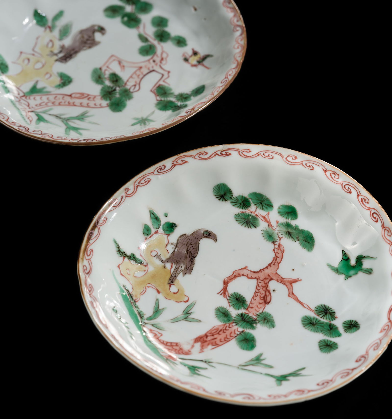 A PAIR OF ENAMELED 'EAGLE AND PINE TREE' FOLIATE DISHES, CHONGZHEN PERIOD: A PAIR OF ENAMELED 'EAGLE AND PINE TREE' FOLIATE DISHES, CHONGZHEN PERIOD China, 1628-1644. The slightly fluted sides rising from a short circular foot and are delicately painted with blue, red, gree